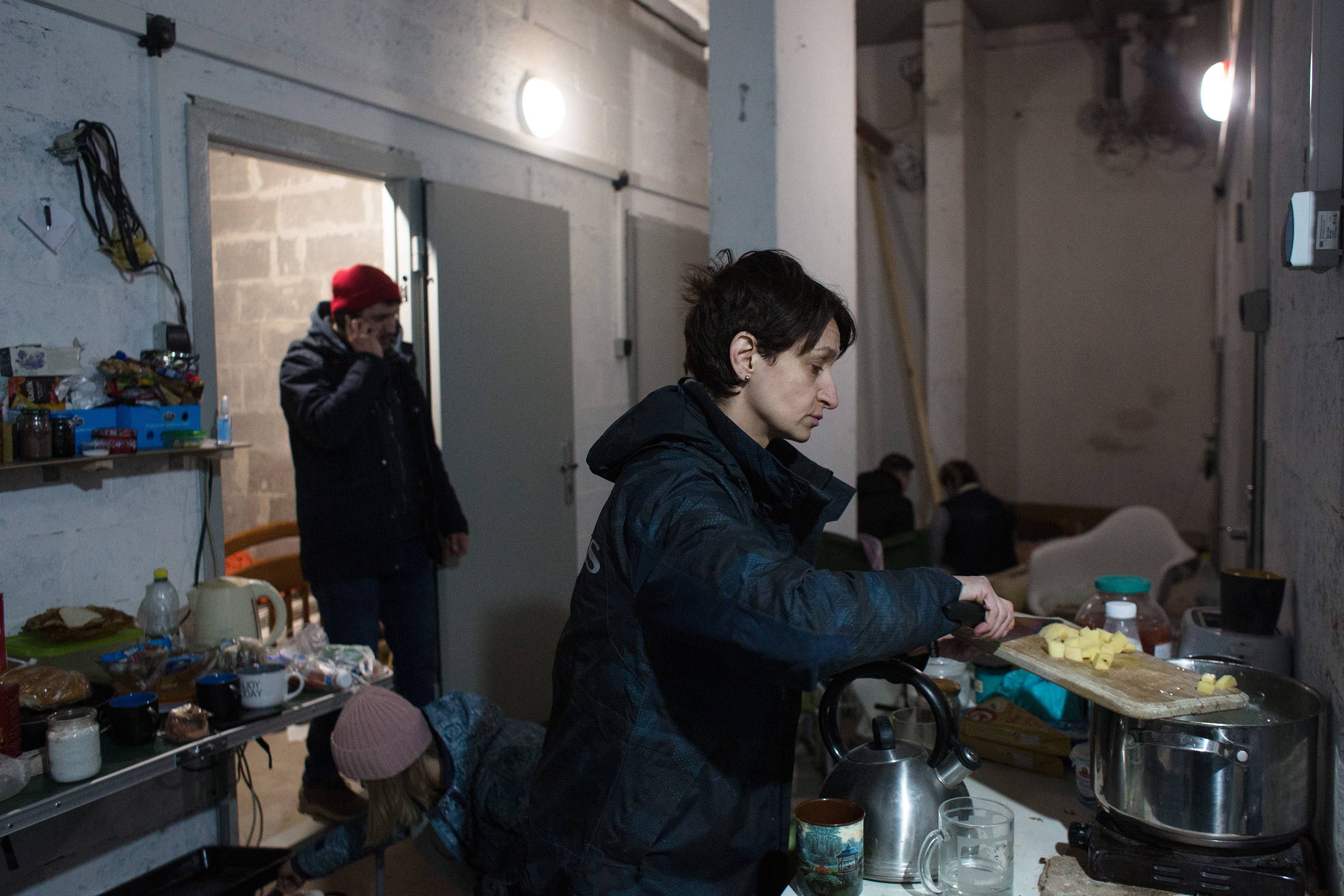 March 21: Iryna Miroshnychenko cooks in the basement of a residential building in Kyiv, where residents shelter from Russian airstrikes and shelling.