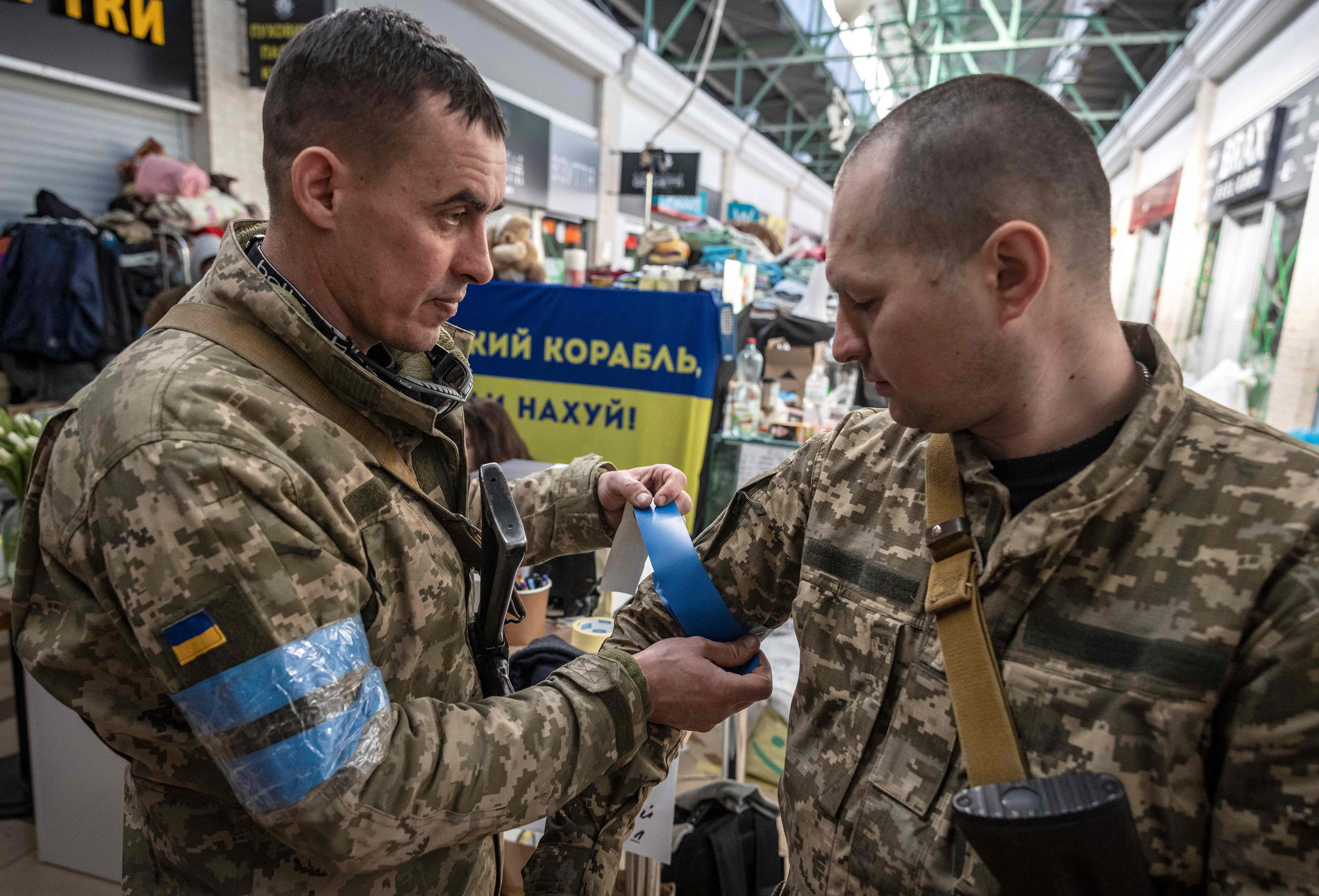 March 21: Ukrainian soldiers put blue tape on their uniforms in Kyiv.