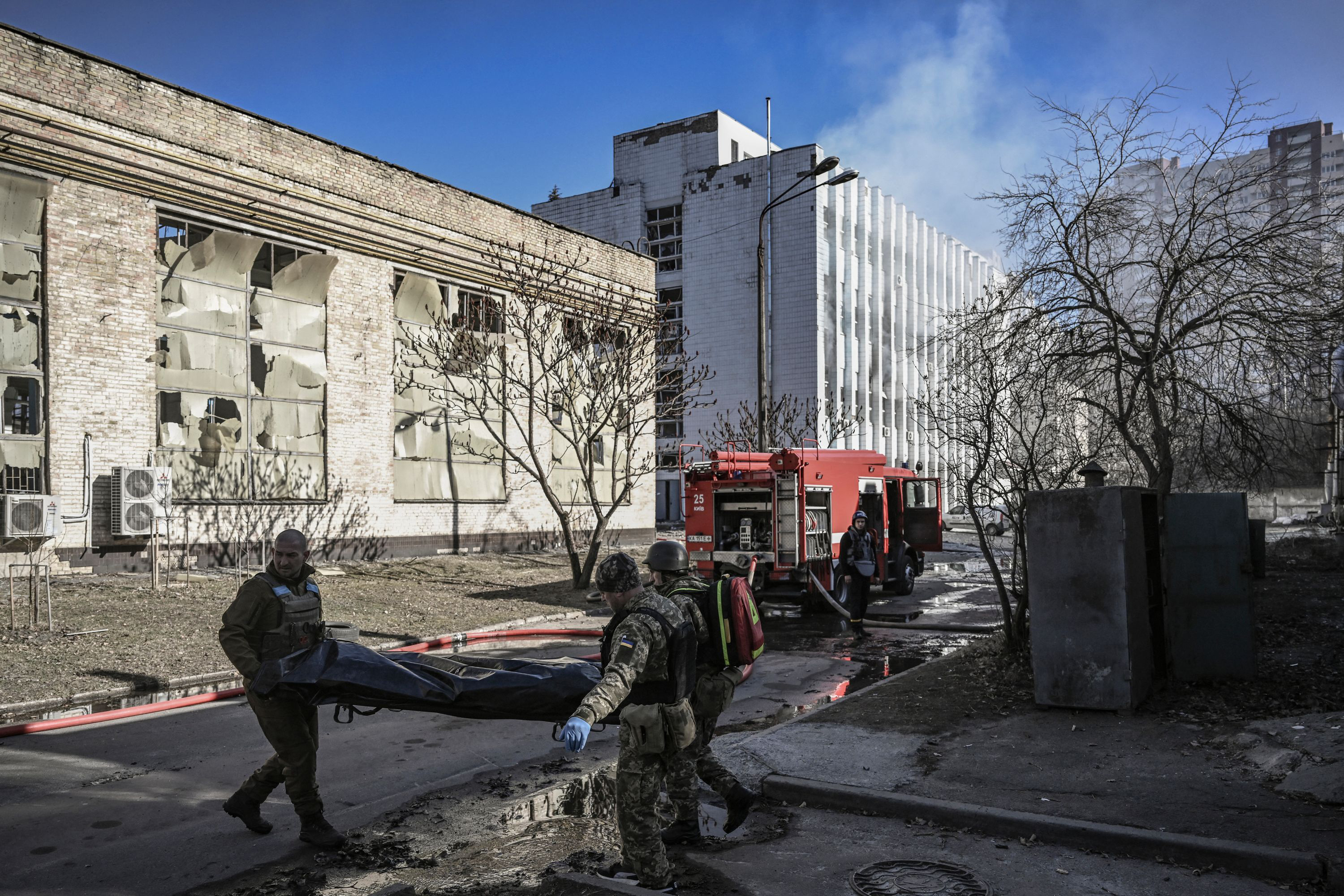 March 22: Military service members remove the body of a Ukrainian serviceman killed near one of the Ukraine's National Academy of Science's research institutes after a strike in northwestern Kyiv.