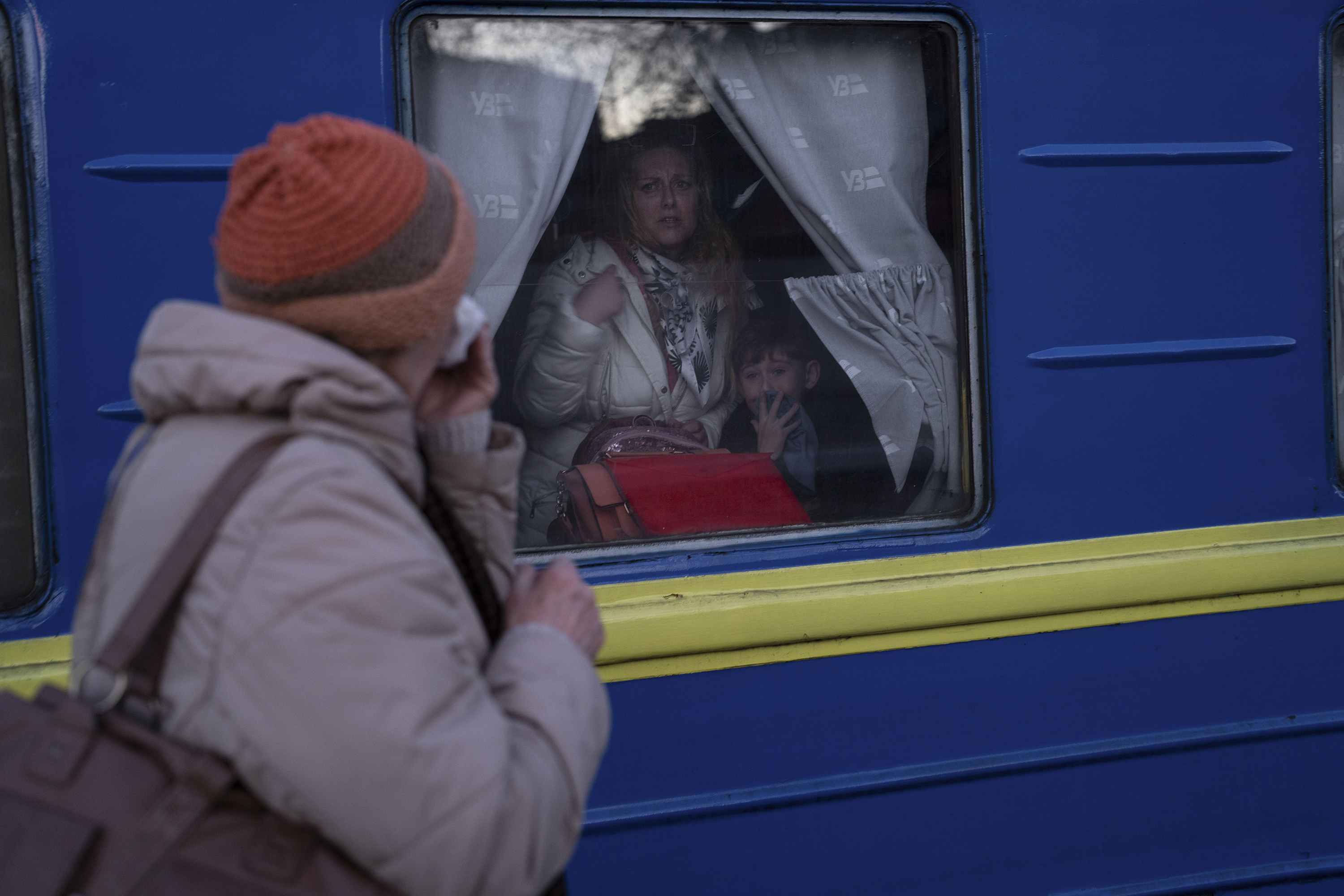 March 22: Ludmila, left, says goodbye to her granddaughter Kristina, who with her son Yaric, are leaving on a train in Odesa.