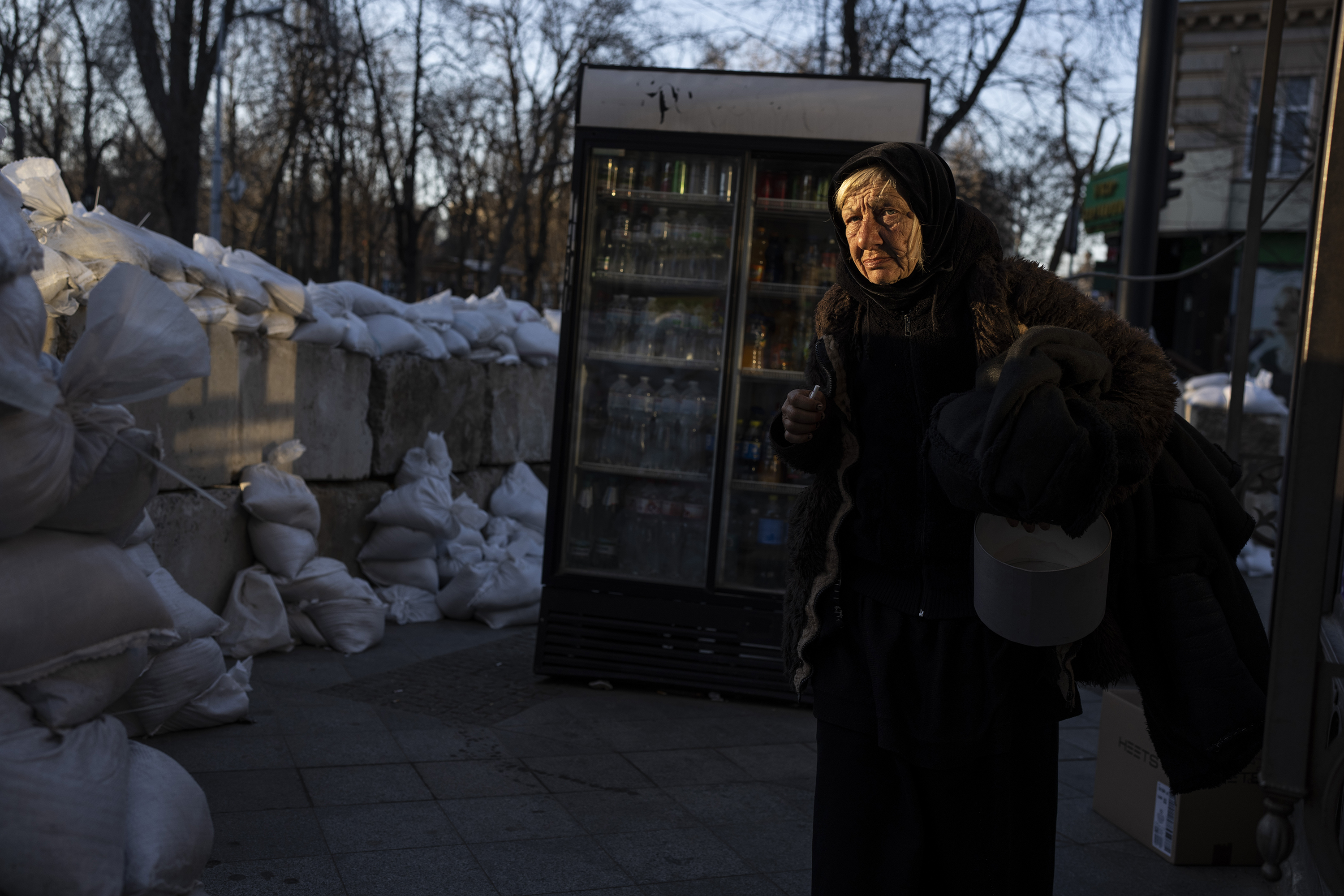 March 22: An elderly woman walks past concrete blocks topped with sandbags along a street in Odesa, in southern Ukraine.