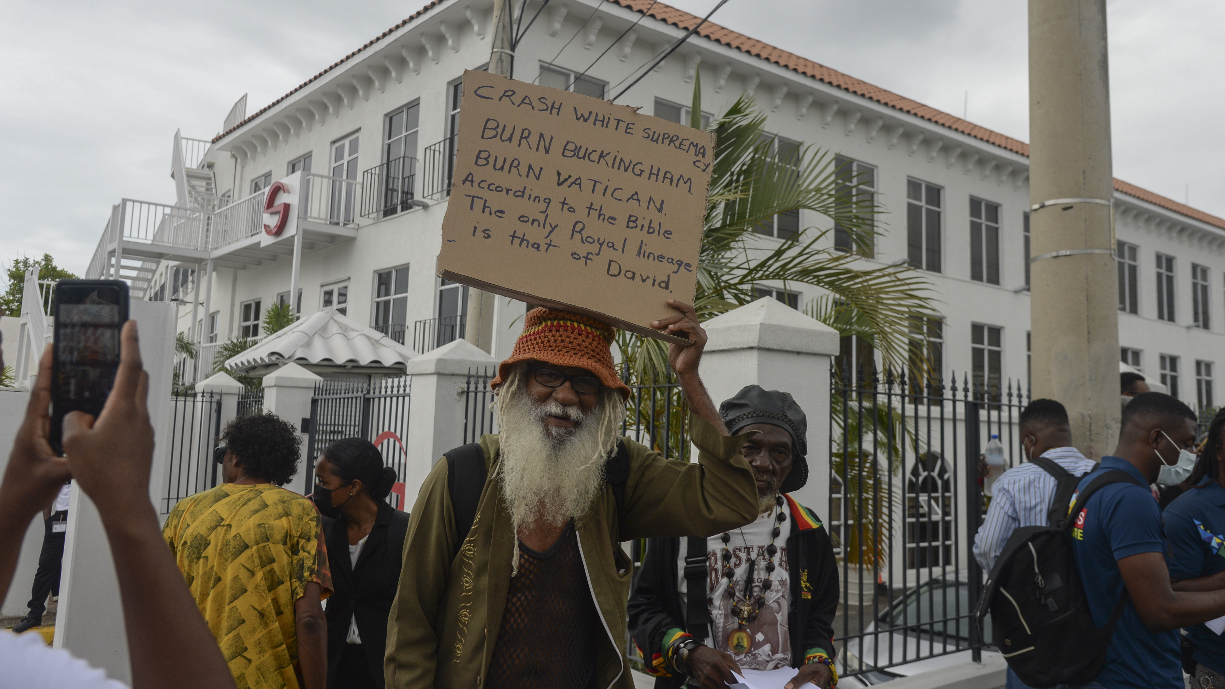 People protest to demand an apology and slavery reparations during a visit to the former British colony by the Duke and Duchess of Cambridge, Prince William and Kate, in Kingston, Jamaica, on Tuesday.