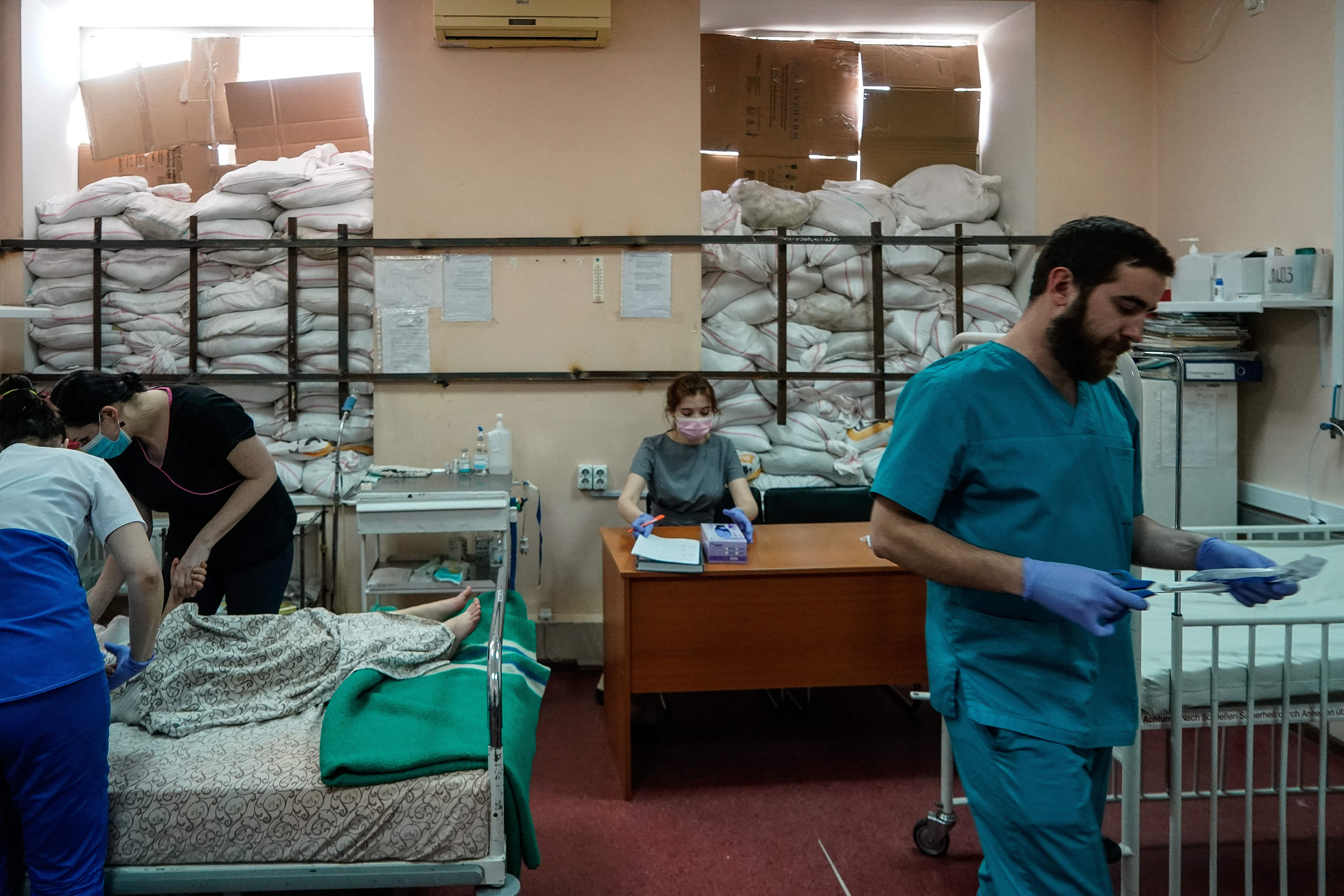 March 22: Medical staff tend to children in a room protected by sandbags at the Zaporizhzhia Regional Children's Hospital.