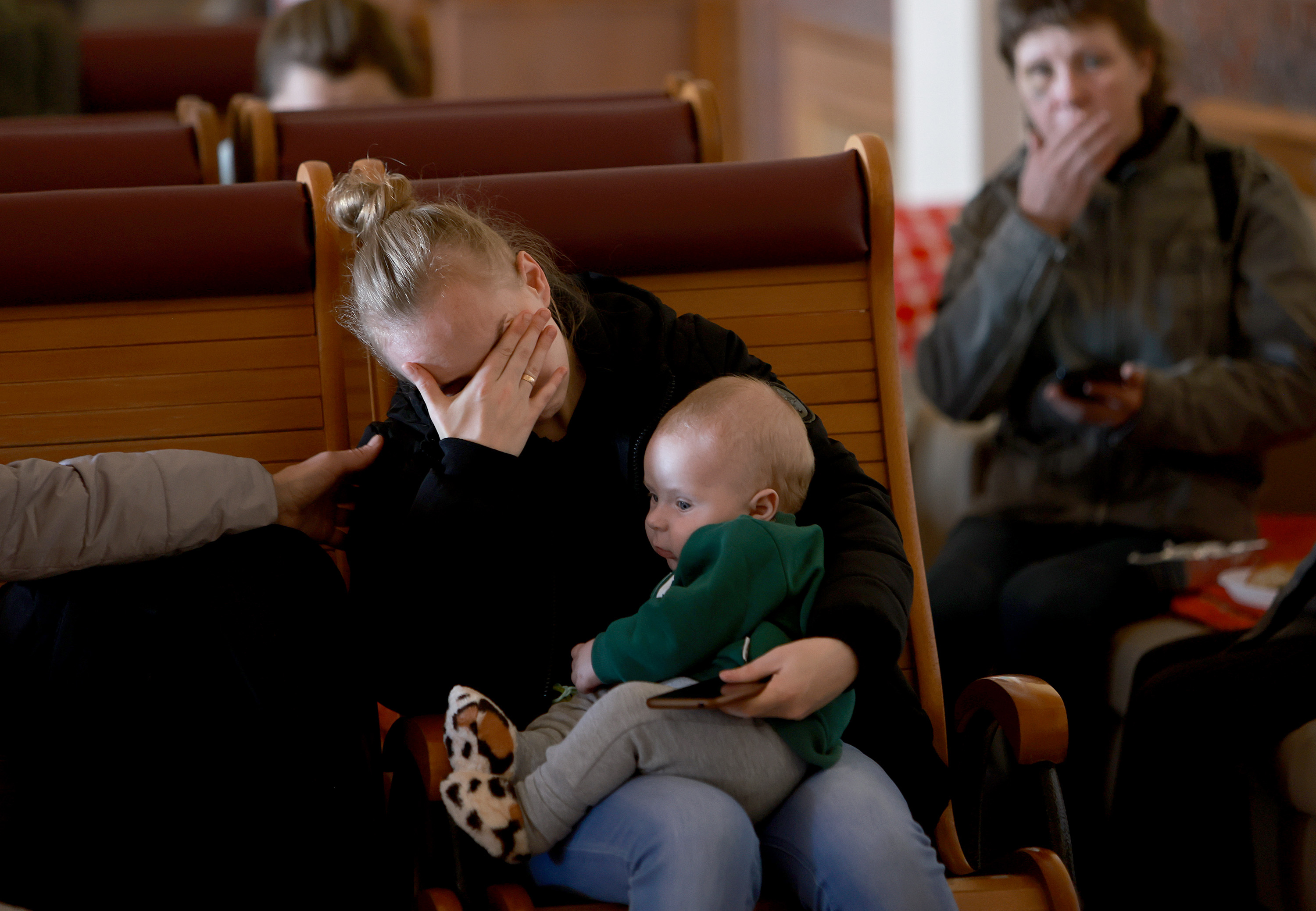 March 23: Yulia (who didn't want to give her last name) cries as she holds her baby, Egor, while staying at a relief center set up at the main train station in Lviv. Yulia, who fled the town of Okhtyrka, said she isn't sure where she's headed and, like others, is trying to find a safe haven away from the Russian military.