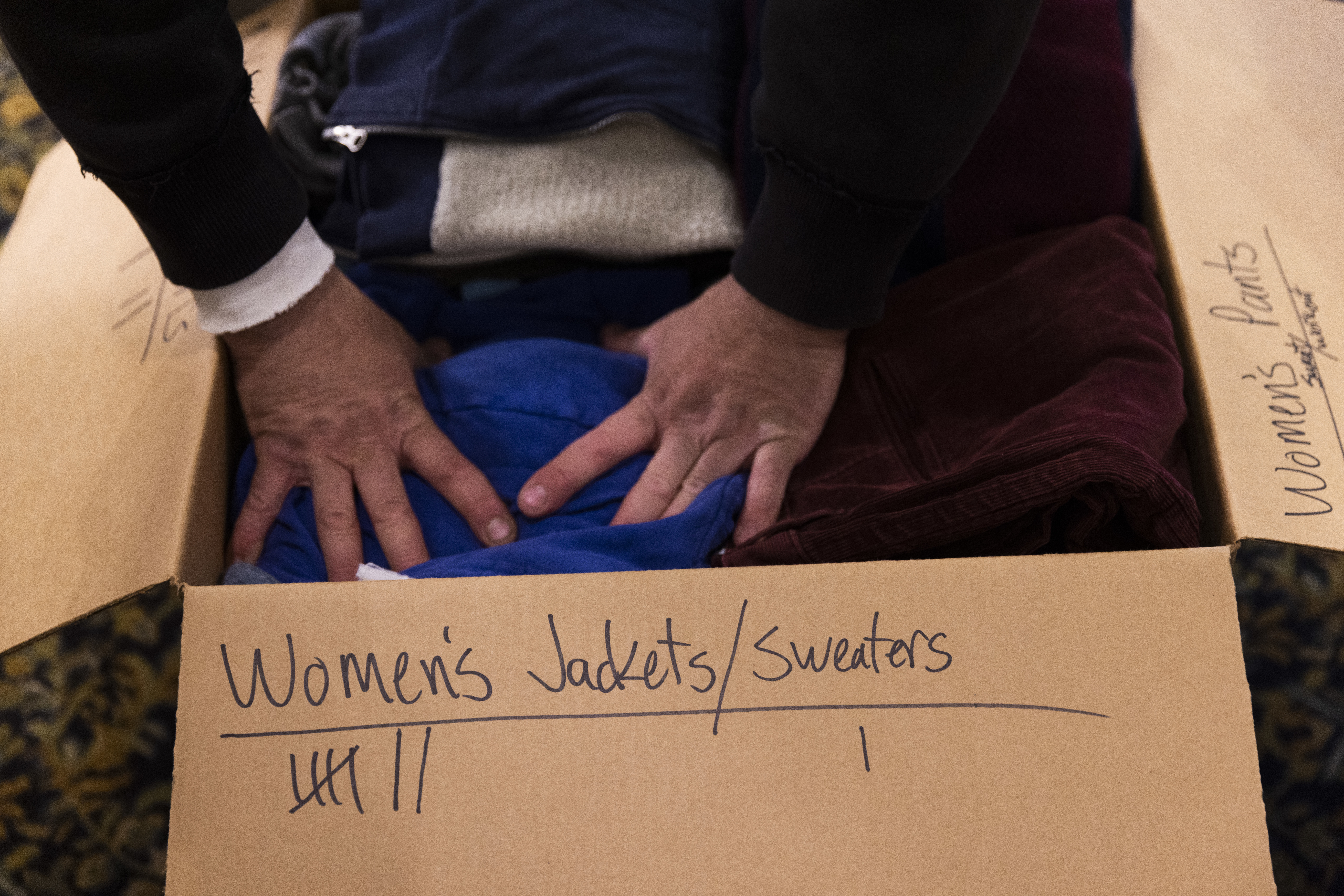 March 10: Jacob Hartenstein packs a box of donated clothing. St. Andrew Ukrainian Orthodox Cathedral in Silver Spring, Maryland receives donations in order to send much-needed supplies to Ukraine, such as clothing, allergy medication for children, trauma care supplies and mobility aids, like crutches.