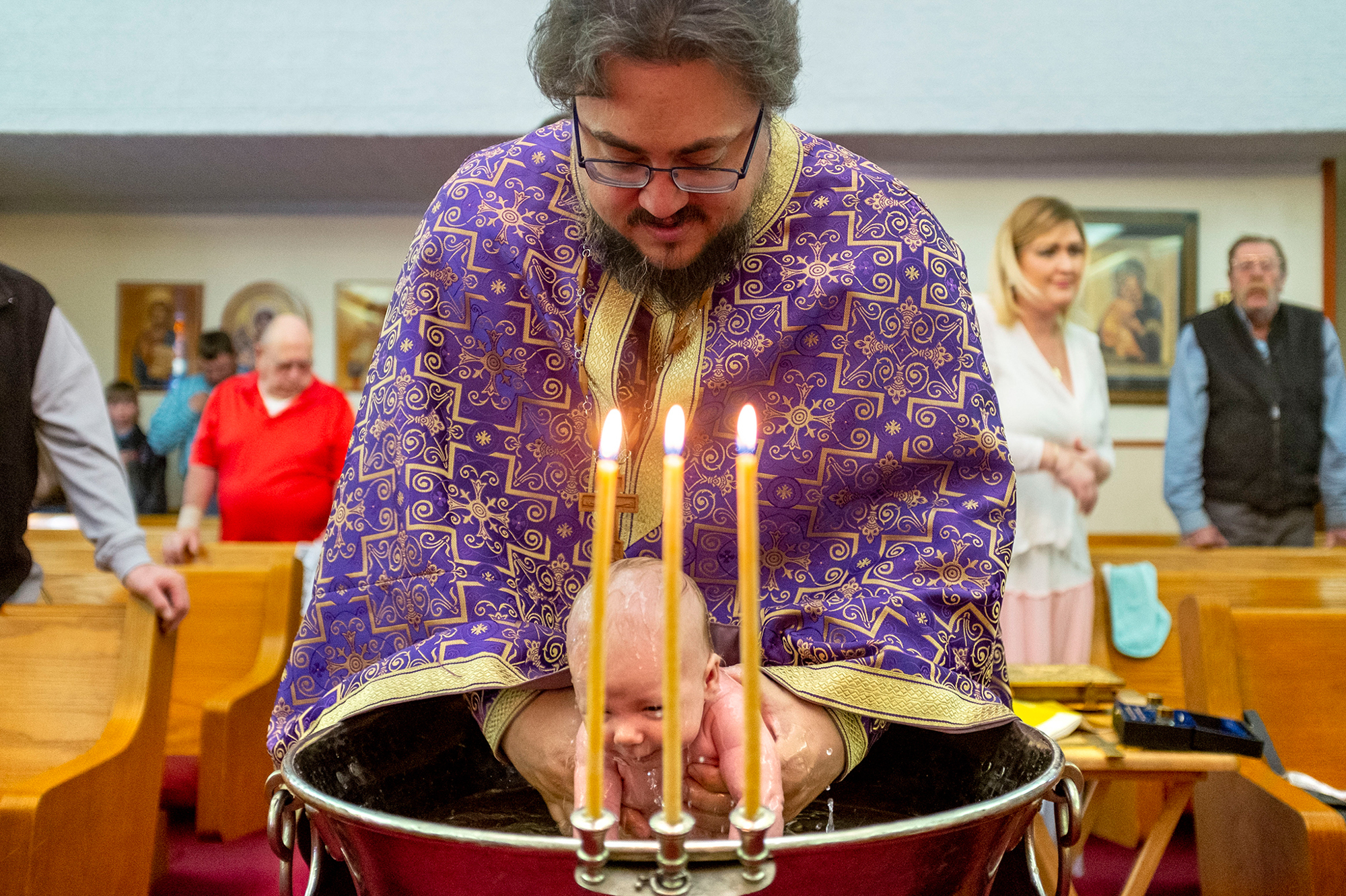 March 13: The Rev. Stephen Osburn baptizes baby Rowelin inside St. Mary's Holy Dormition Orthodox Church in Simla, Colorado.