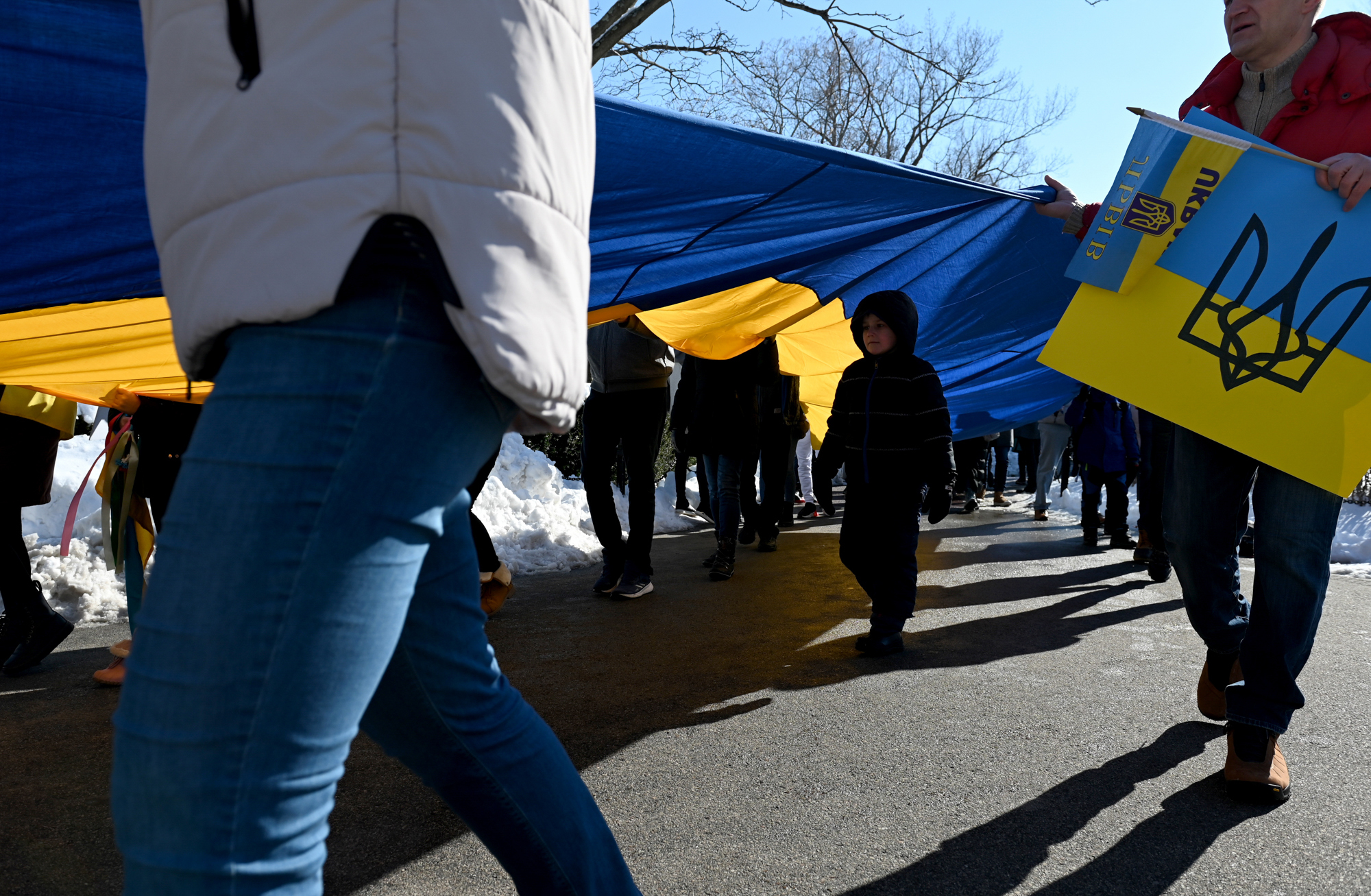 Feb. 27: Marko, a young boy who is originally from Ukraine but now lives in Harvard, Massachusetts, walks under a large flag being carried during a rally in support of Ukraine on the Boston Common.