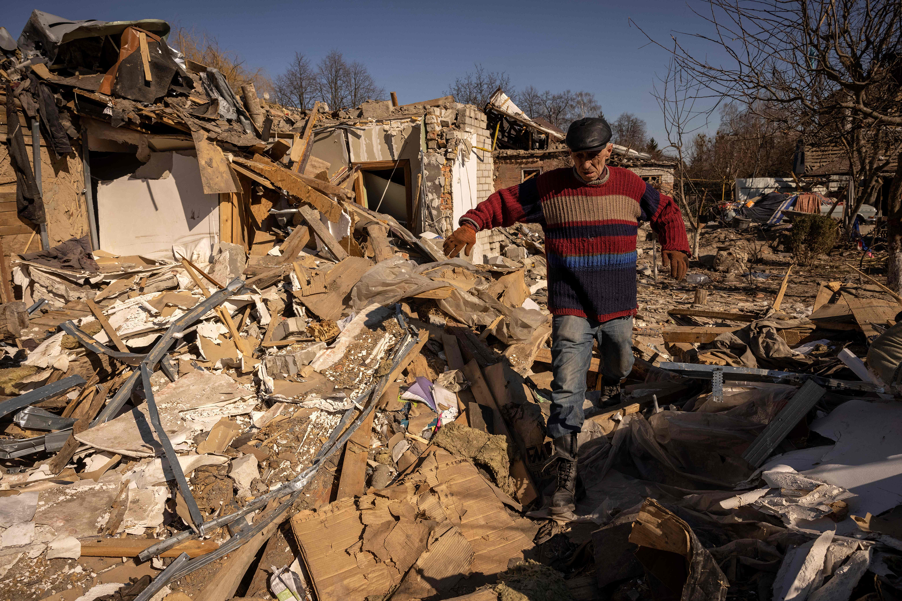 March 23: A man walks in front of a damaged house in the city of Zhytomyr, in northern Ukraine.
