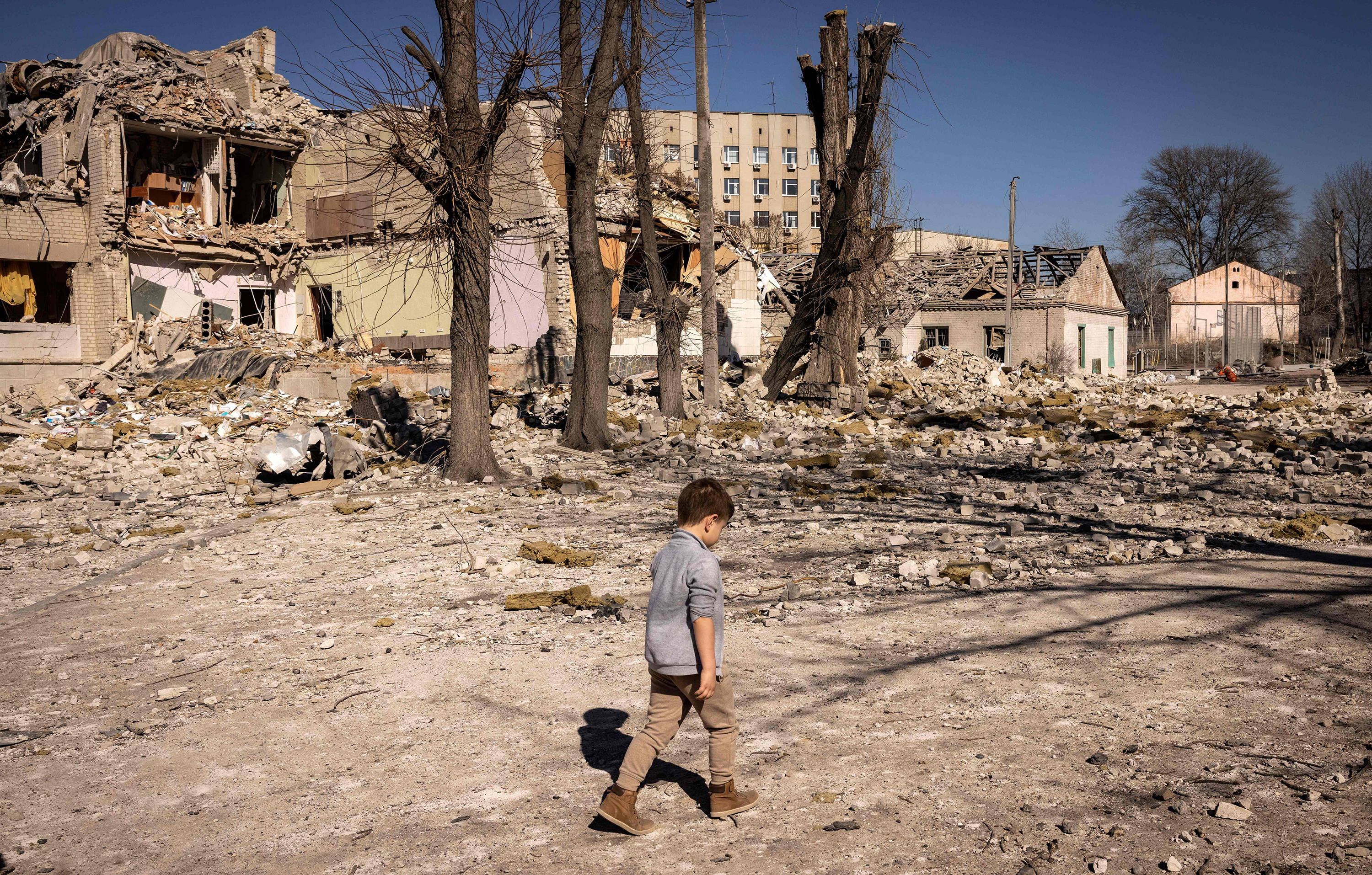 March 23: A child walks in front of a damaged school in the city of Zhytomyr, in northern Ukraine.