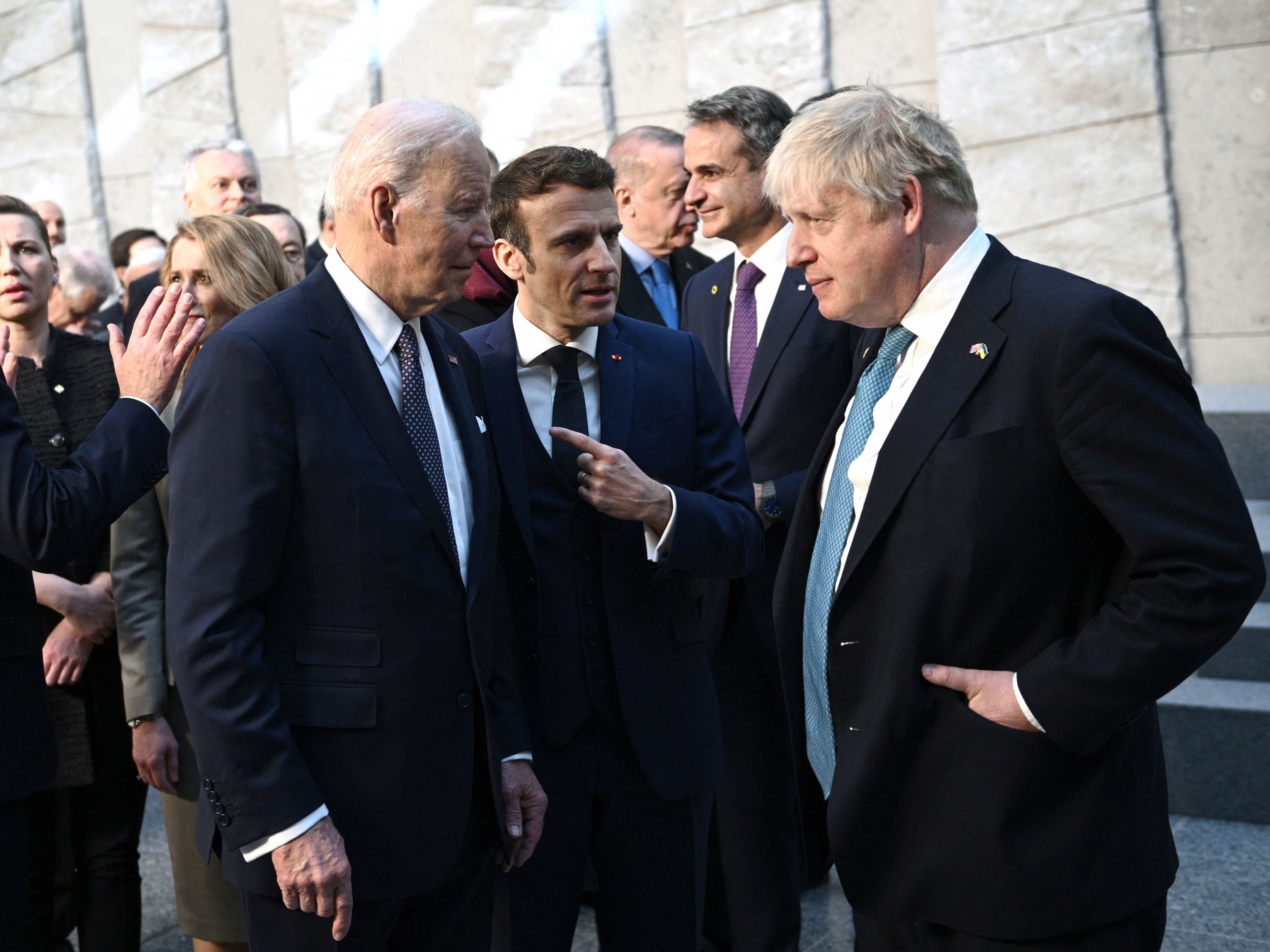 President Biden talks with British Prime Minister Boris Johnson and French President Emmanuel Macron as they arrive at NATO headquarters in Brussels for an emergency meeting on Russia and Ukraine. (POOL/AFP via Getty Images)