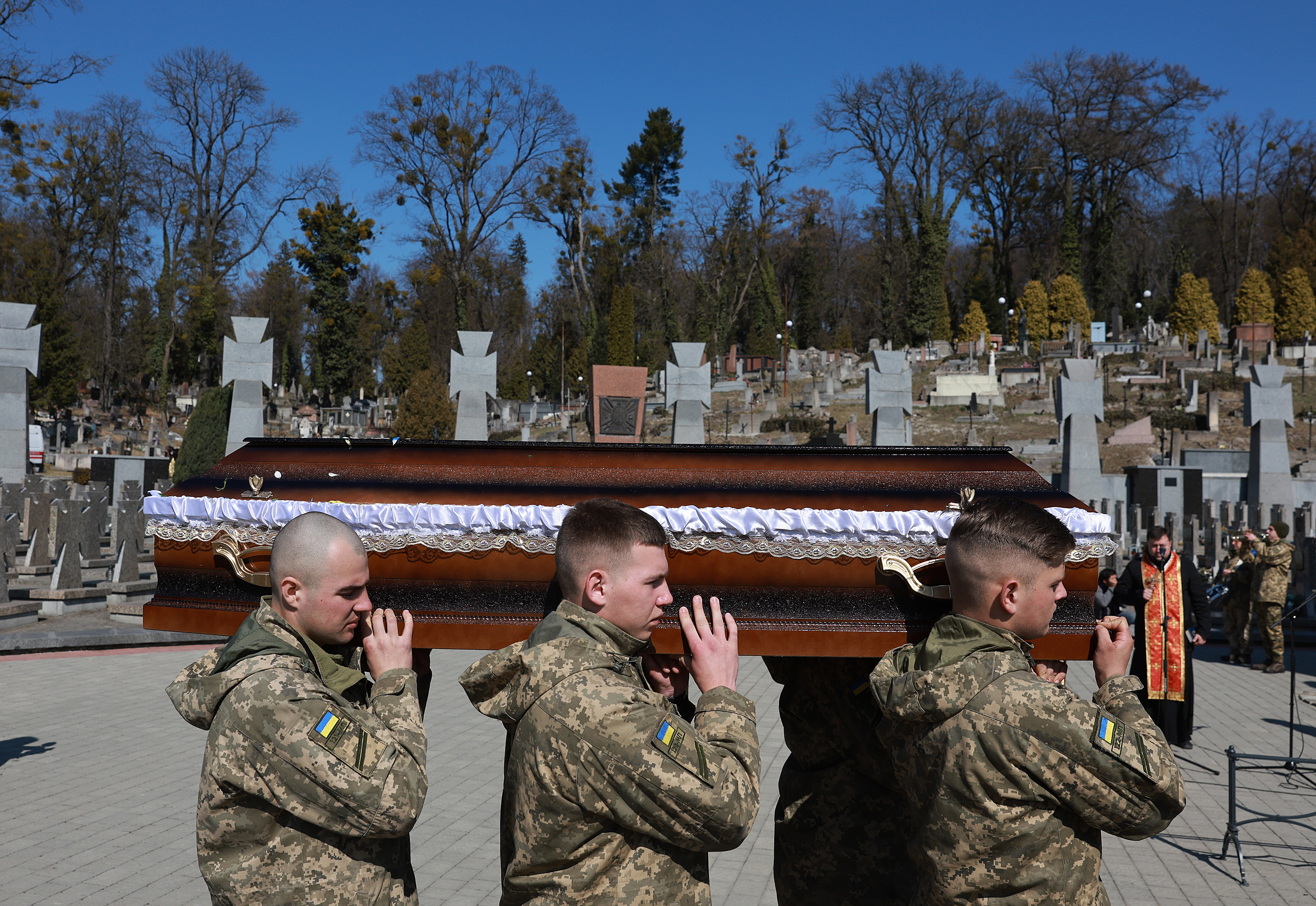 March 24: Members of the Ukrainian military carry the casket of Fedorchyk Ihor Vododymyrovych to his grave during his burial at the Lychakiv Cemetery in Lviv.