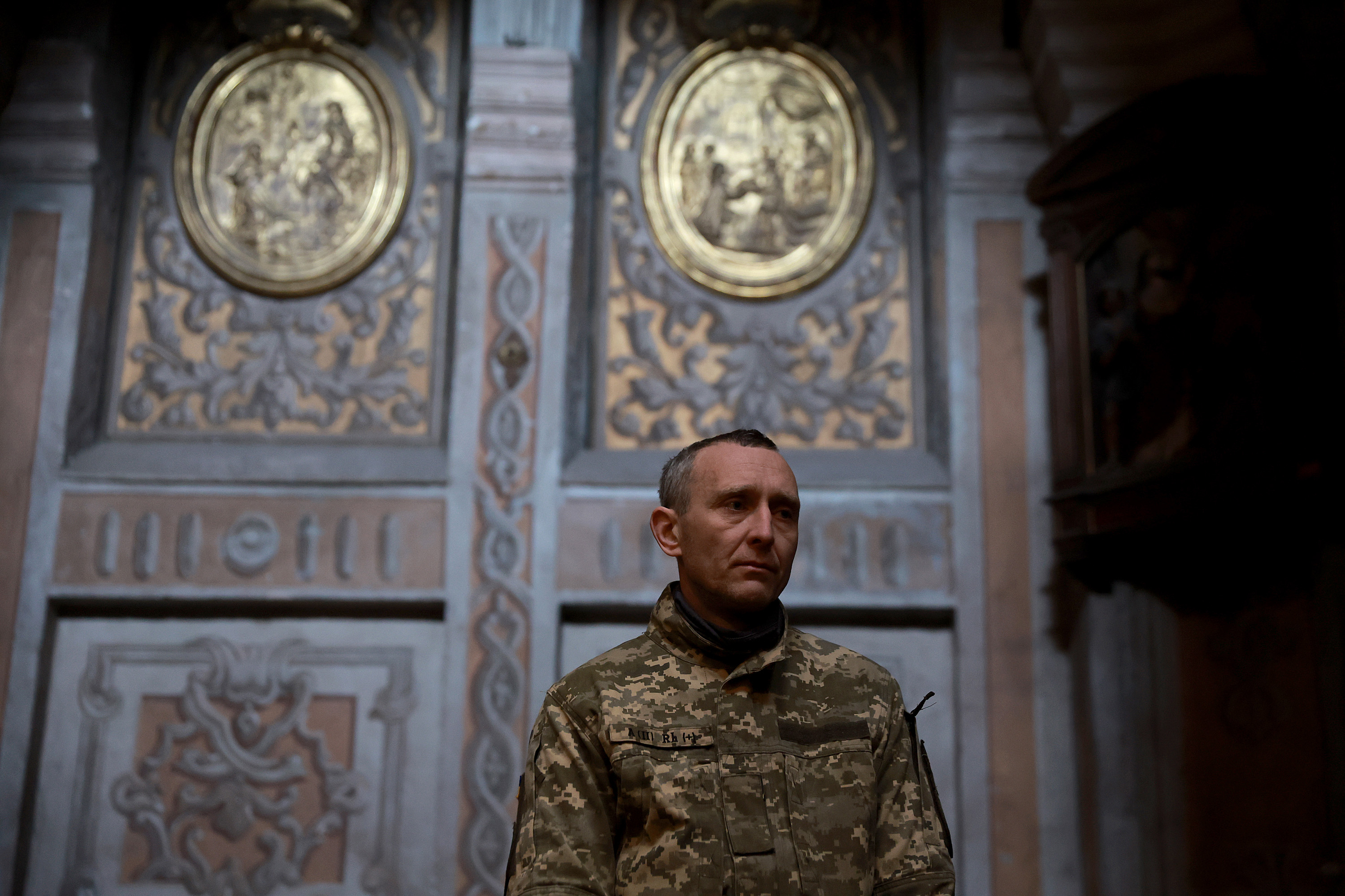 March 24: A member of the Ukrainian military attends the funeral for Fedorchyk Ihor Vododymyrovych at the Church of the Most Holy Apostles Peter and Paul in Lviv.