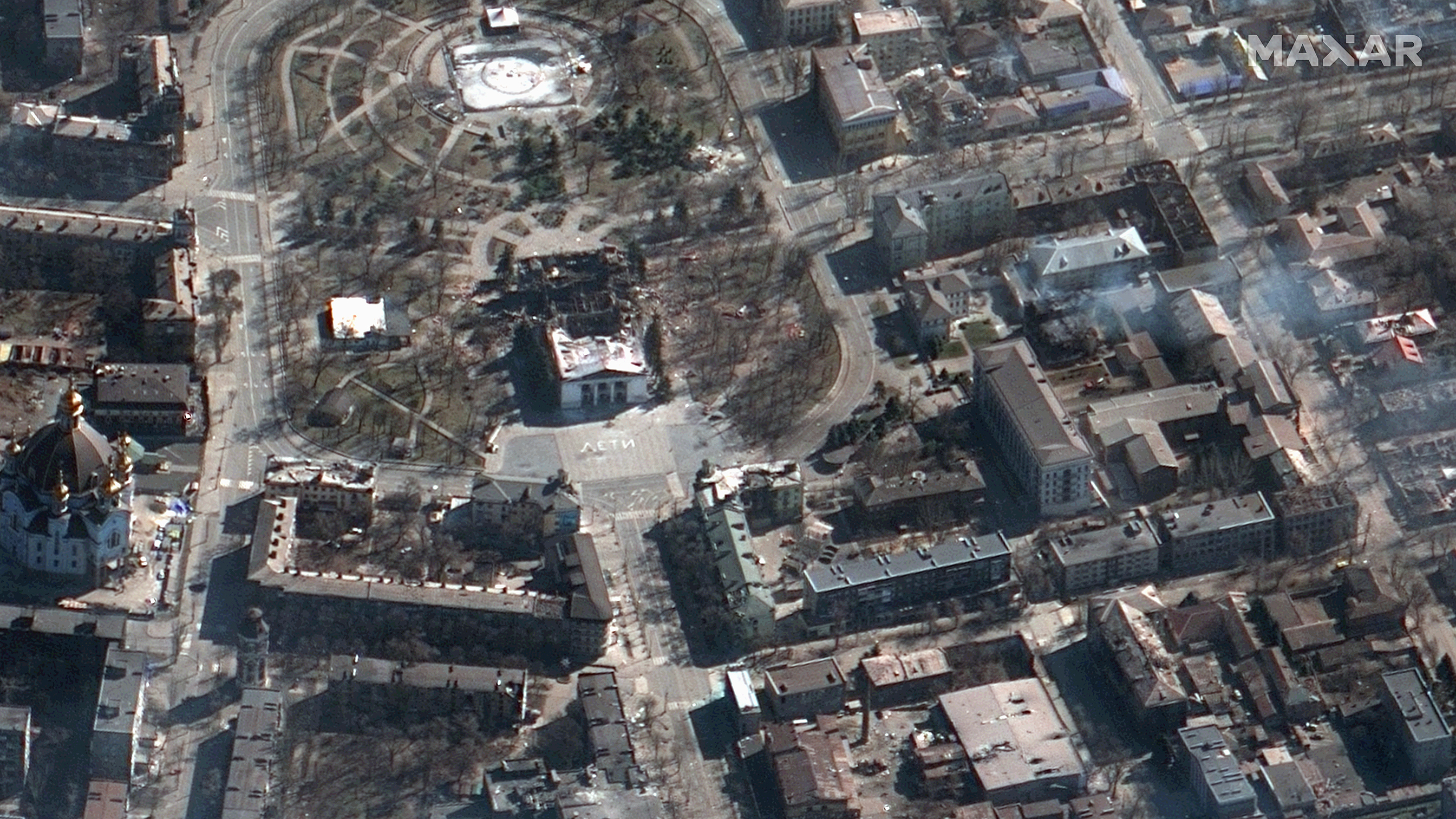 A satellite image shows the destruction wrought on the theater (center left) in Mariupol, Ukraine. The city council says around 300 people are believed to have died in the bombing. (Satellite Image ©2022 Maxar Technologies)