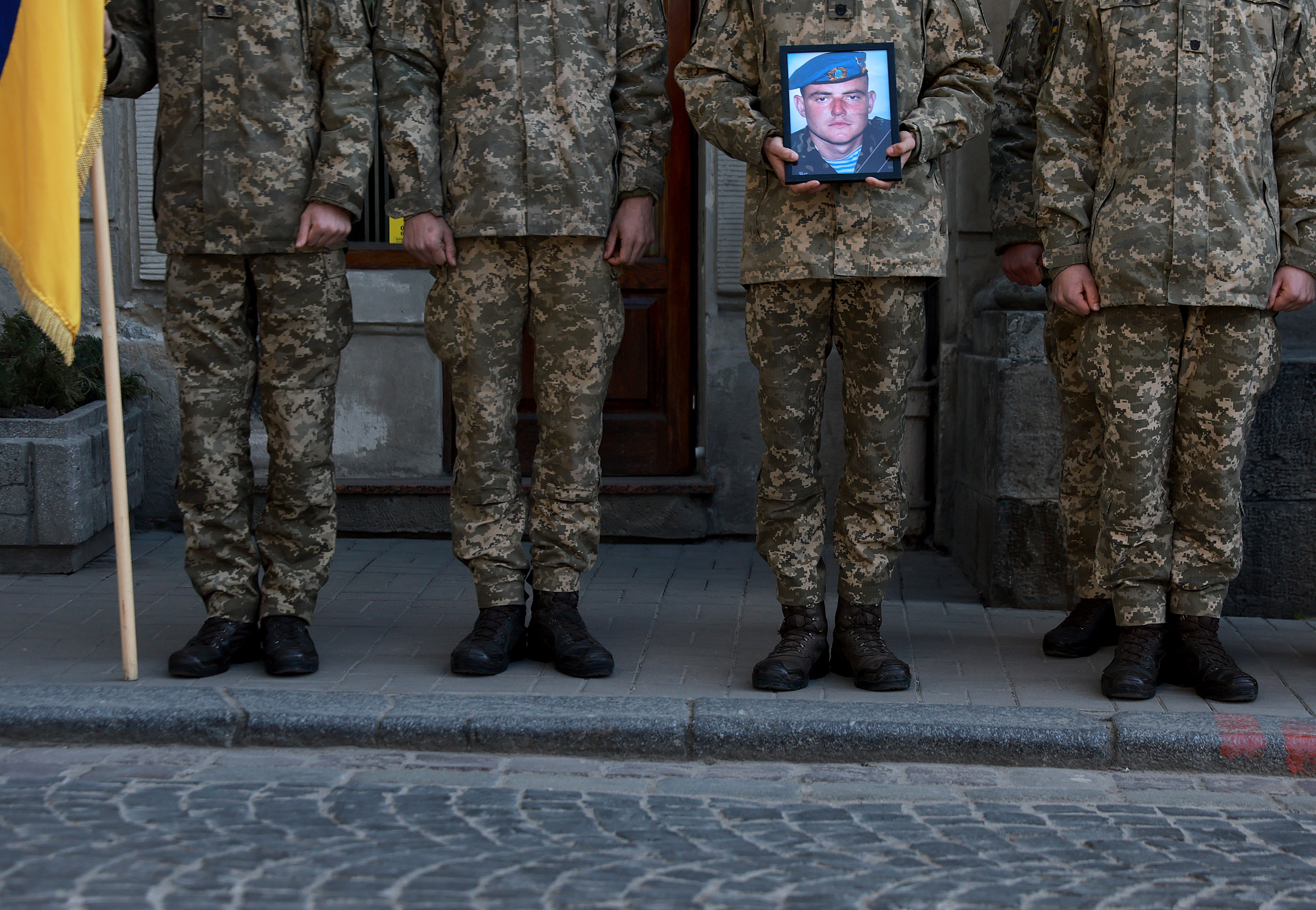 March 25: Ukrainian military members hold a picture of Ukrainian Air Assault paratrooper Volodymy Rurak during his funeral at the Church of the Most Holy Apostles Peter and Paul in Lviv, Ukraine.
