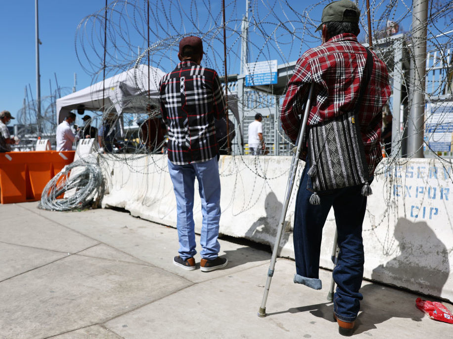 An asylum seeker waits outside the San Ysidro Port of Entry in Tijuana, Mexico. The Biden administration is bracing for a possible surge in migration if it lifts the pandemic border restrictions known as Title 42. (Getty Images)