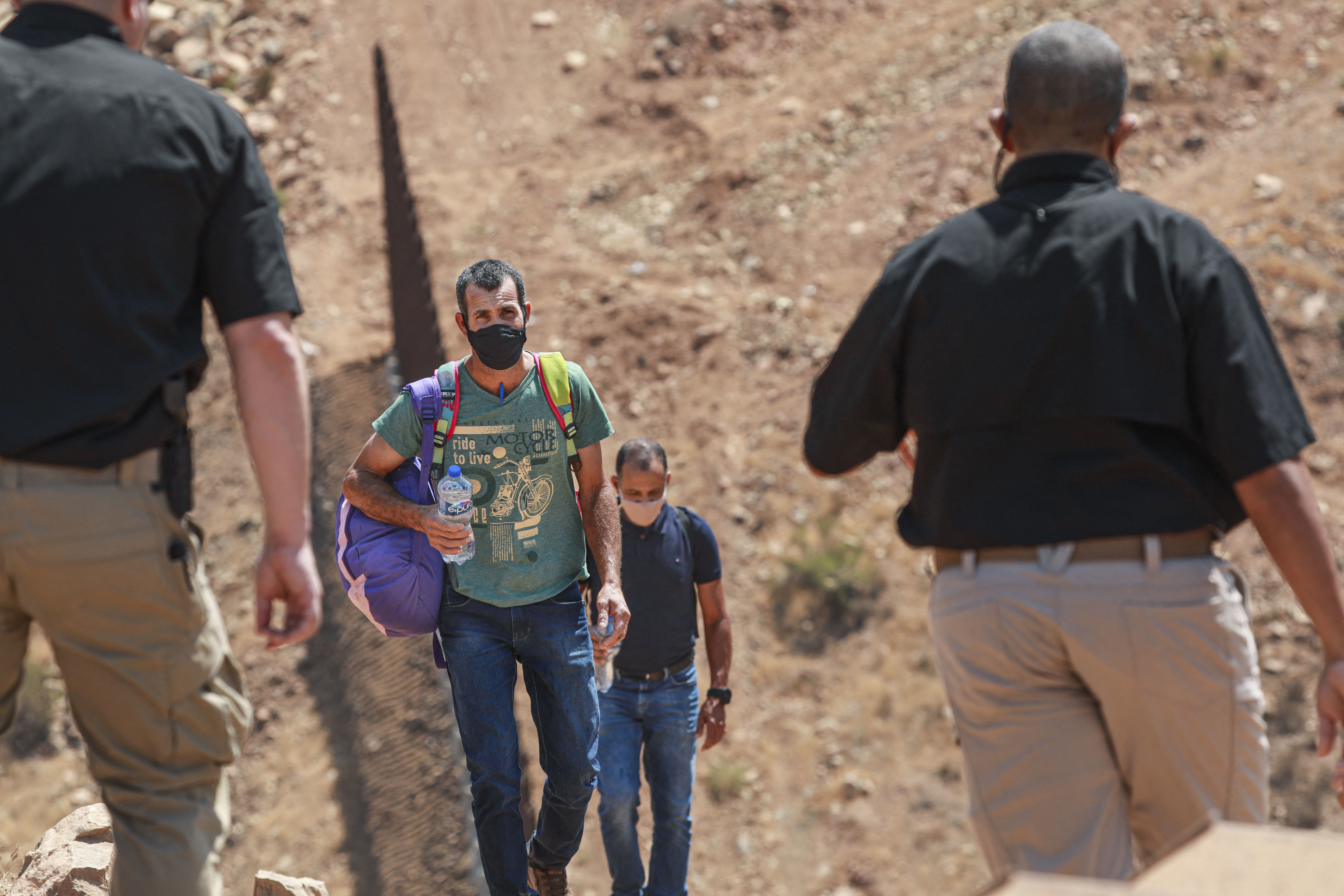 Customs and Border Protection agents apprehend a group of Brazilian migrants in Otay Mesa, Calif., in August 2021. (AFP via Getty Images)