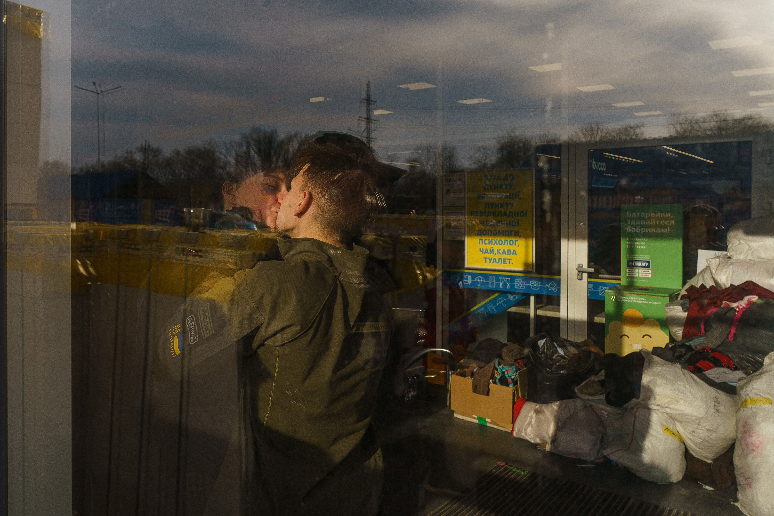 March 29: Lina and Vlad, both volunteers, kiss each other at the registration center in Zaporizhzhia.