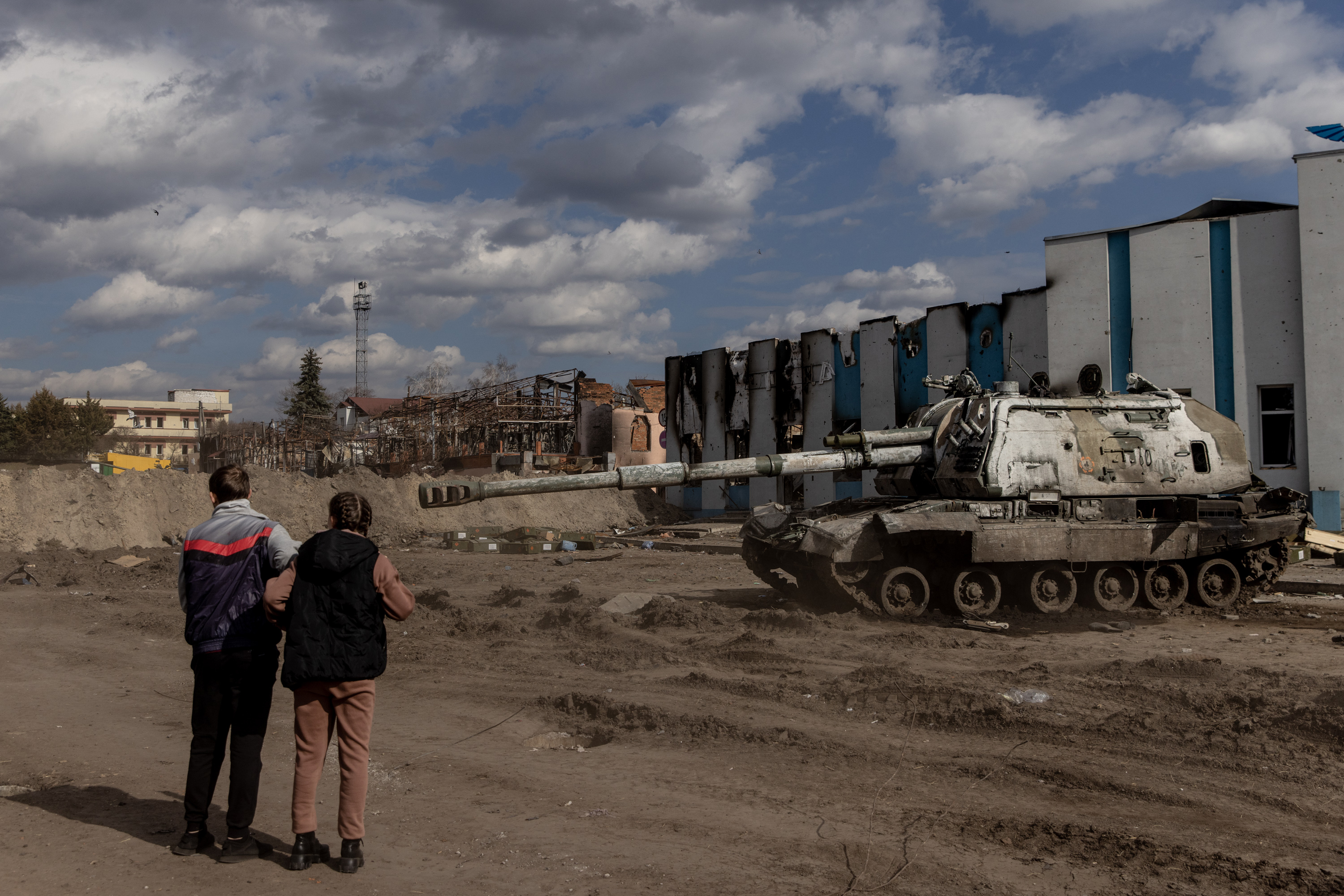 March 29: Residents look at a destroyed Russian tank close to the central train station that was used as a Russian base in Trostyanets.