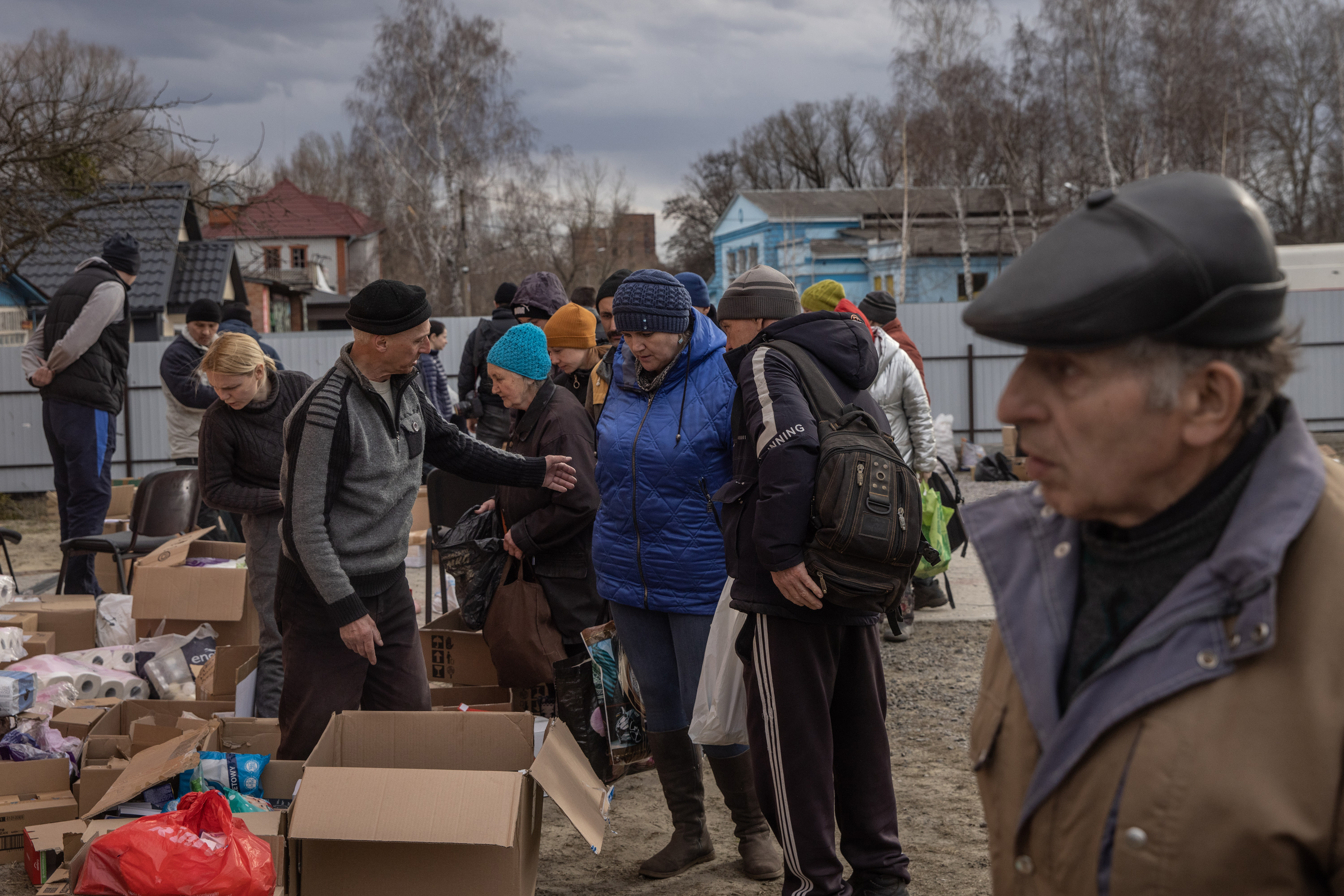March 29: Residents collect food at a humanitarian aid station in Trostyanets.