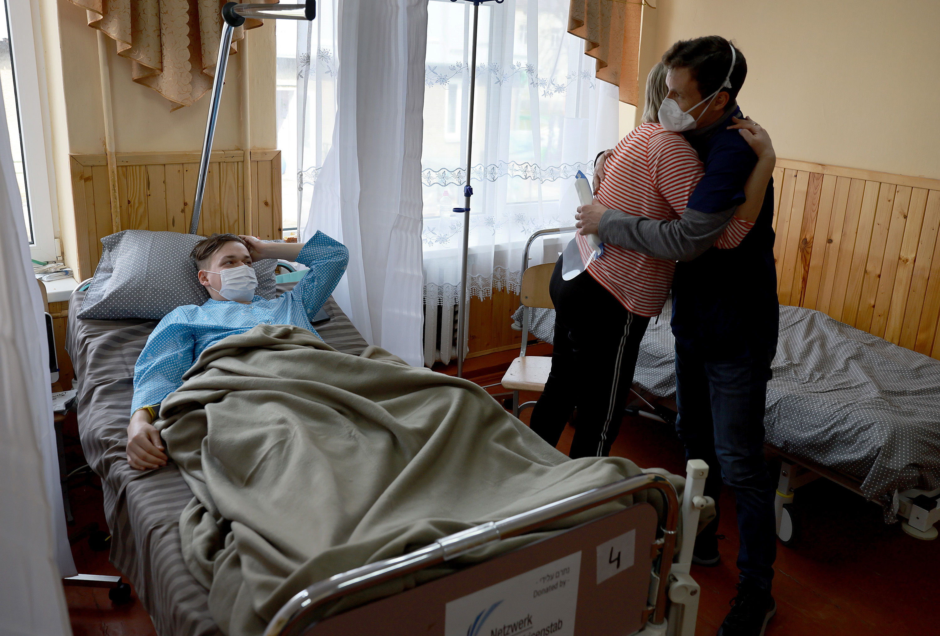 March 30: Nadia Stasishin hugs Dr. Mikhail Bazhmin after he's given her the news that her son, Yura Stasishin (left), would be okay after he experienced an epileptic seizure and found treatment at an Israeli field hospital in Mostyska, Ukraine.