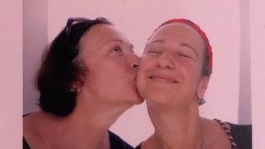 Vita Linnik (left) and Sofia Bretl smile and pose in a photo booth during happier times.