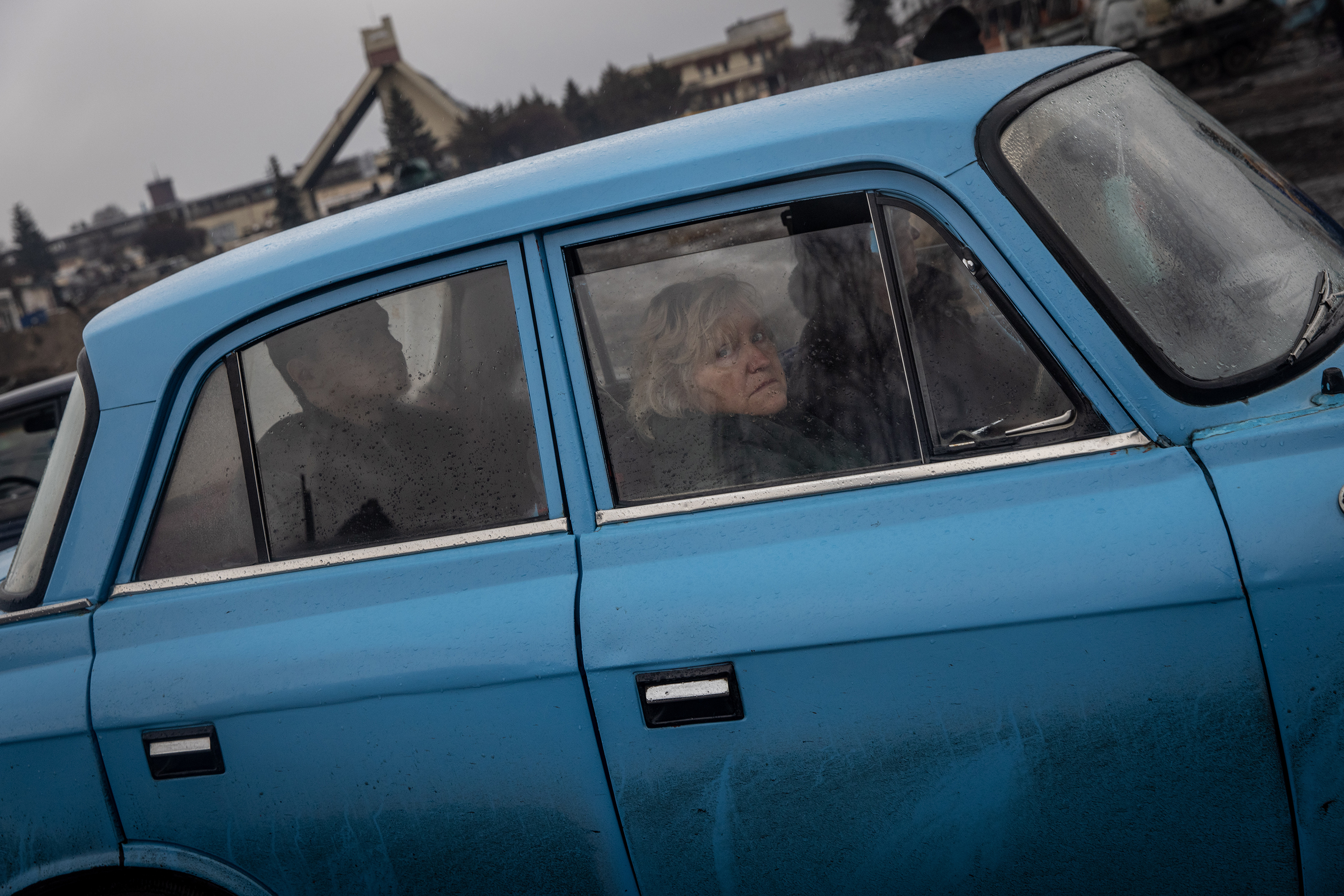 March 30: People in a car look at a destroyed Russian tank close to the central train station that was used as a Russian base in Trostyanets.