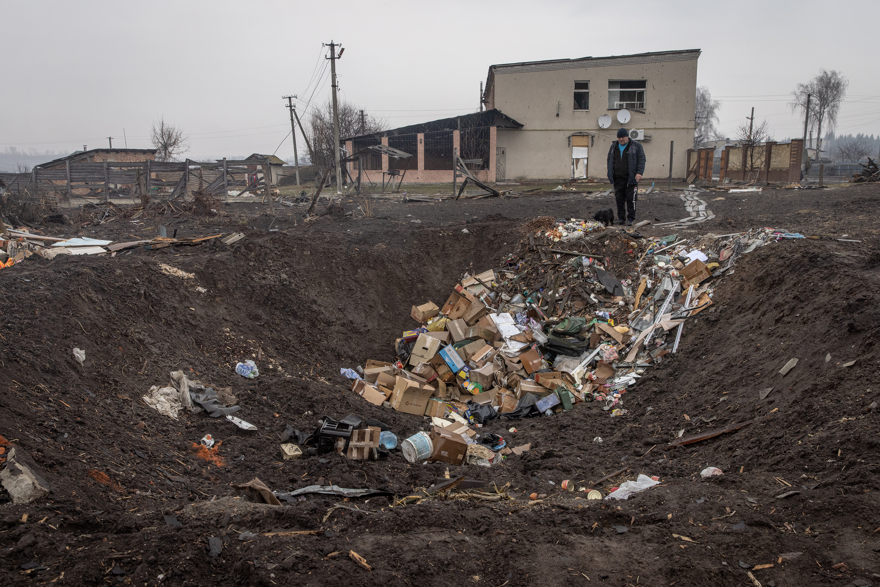 March 30: A man stands with his dog at the edge of a rocket crater in Boromlya. The town was recently recaptured by Ukrainian forces. Boromlya lies 40km south of Sumy, the regional capital, which has been heavily bombarded by Russian forces.