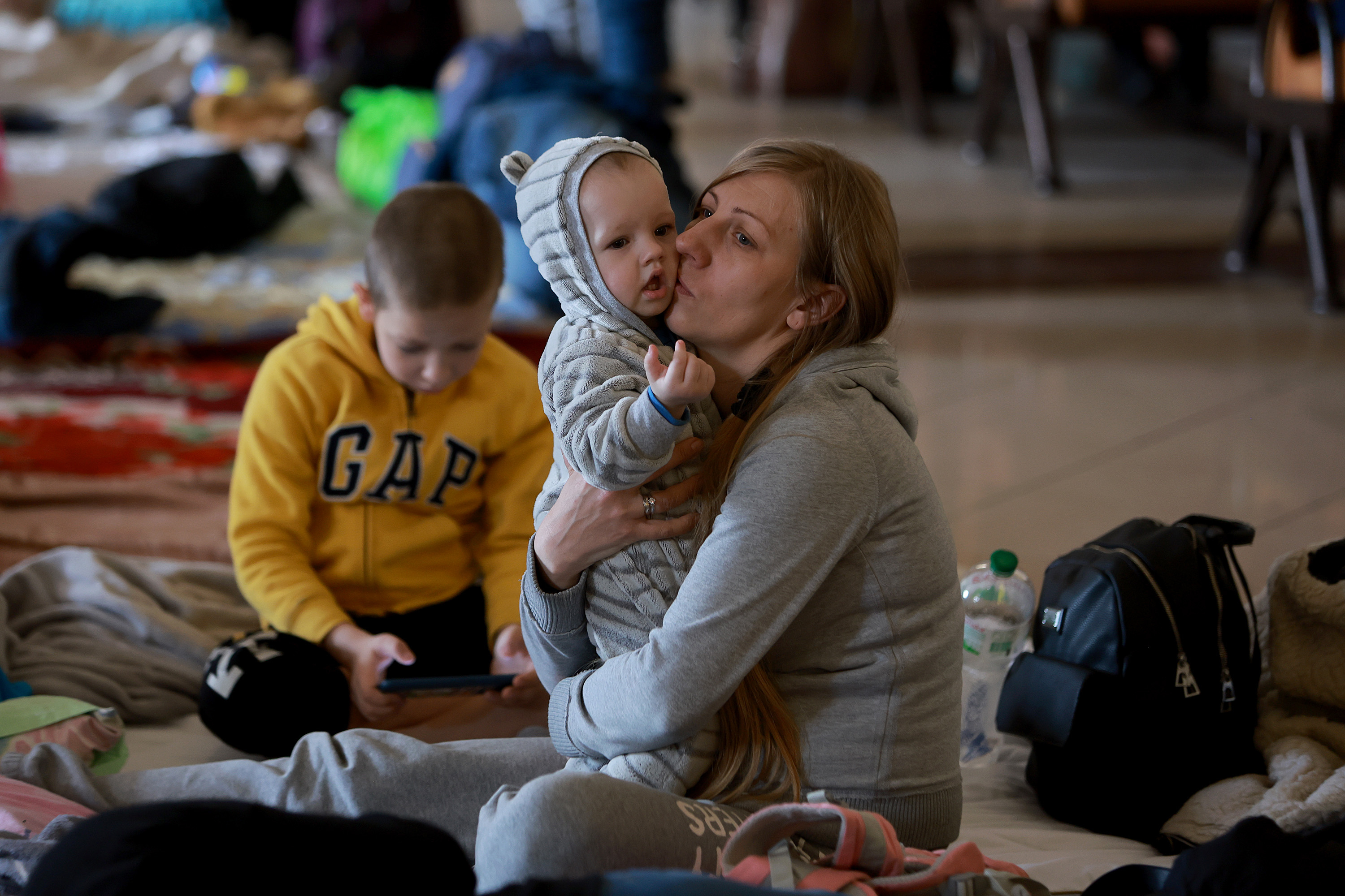 March 31: Olya Melnik comforts her baby, Nicks Melnik, while they rest at a temporary refugee center set up at the main train station in Lviv. Olya said she is trying to make it to Germany after fleeing Kyiv.
