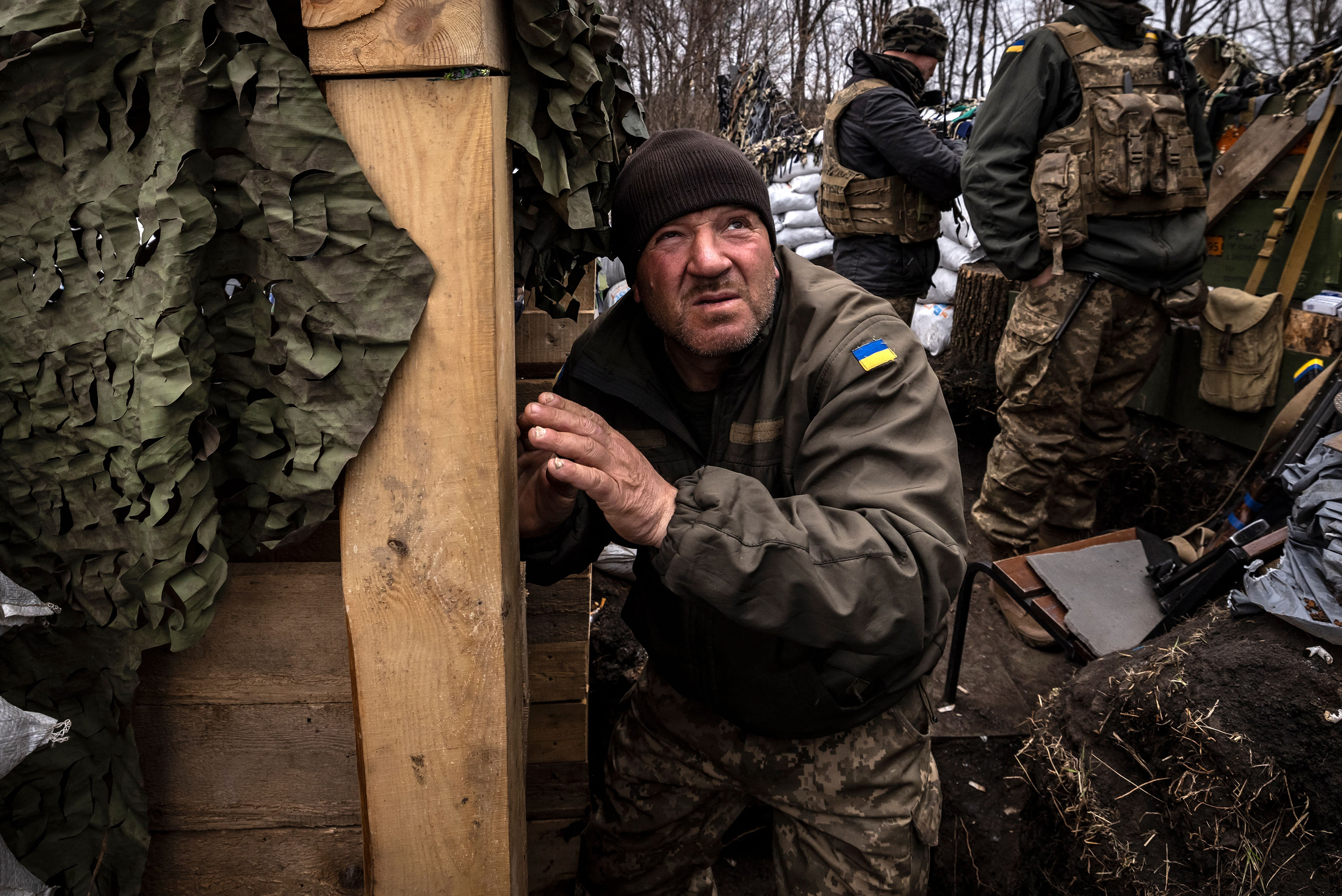 March 31: A Ukrainian serviceman looks on as he waits in a trench at the front line east of Kharkiv.