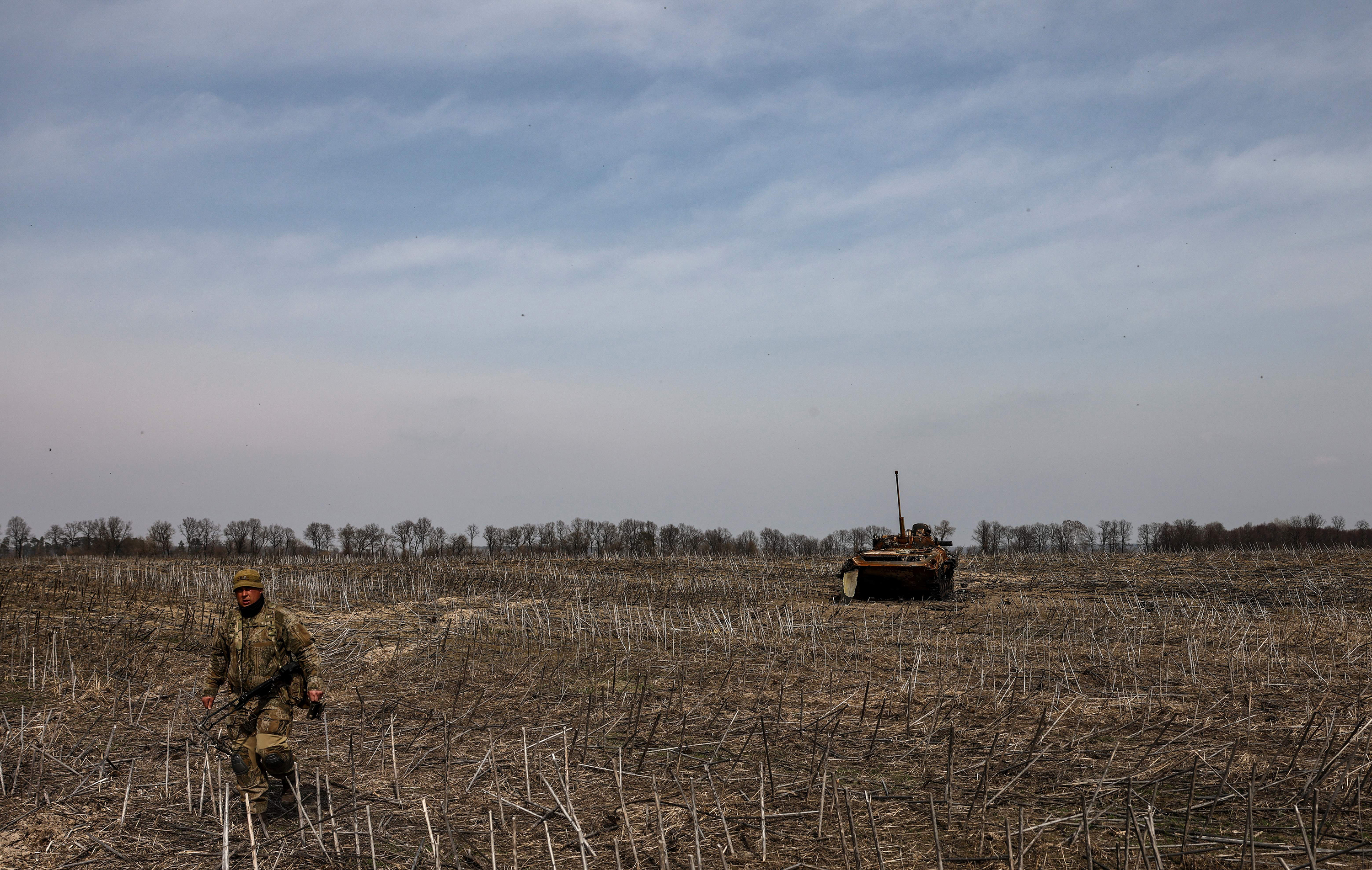 March 31: A Ukrainian soldier walk near the wreckage of a Russian tank on the outskirts of Kyiv, amid Russian invasion of Ukraine.