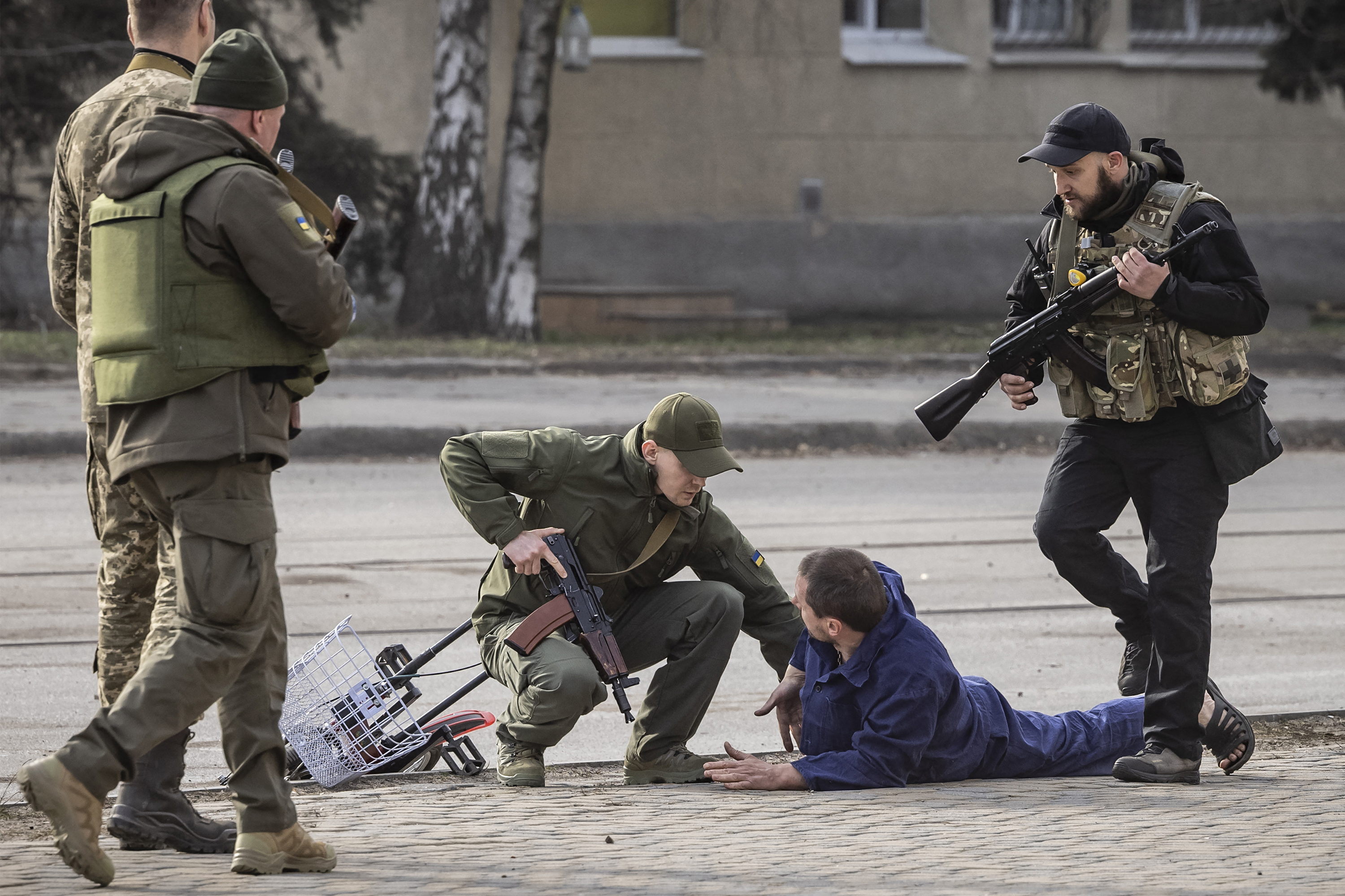 March 31: Ukrainian servicemen check passers-by after a bombardment in the city of Kharkiv, during Russia's invasion launched on Ukraine.