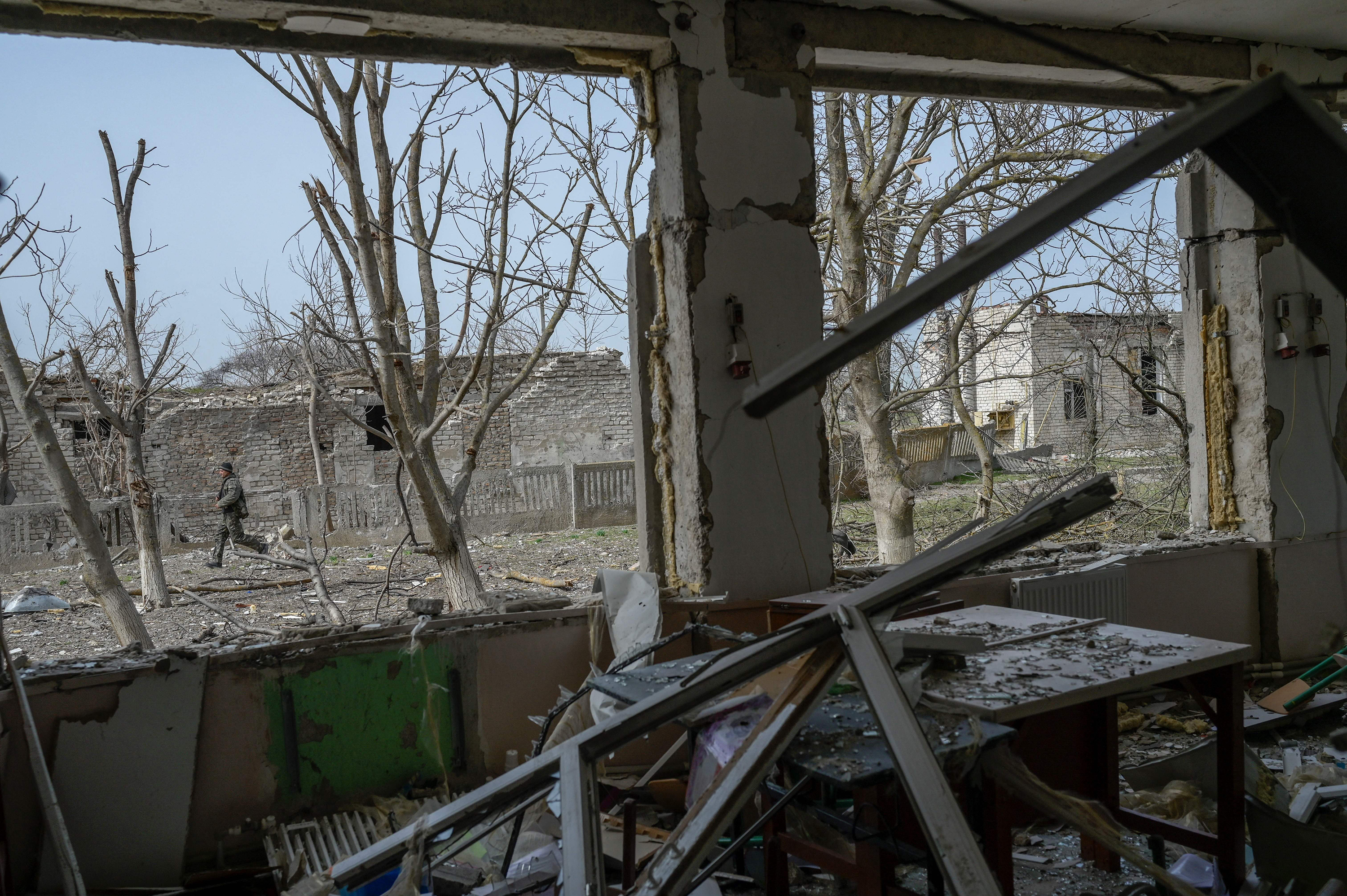 April 1: A Ukrainian soldier walks outside a school hit by Russian rockets in the southern Ukraine village of Zelenyi Hai between Kherson and Mykolaiv, less than 5km from the front line, as NATO says it is not seeing a pull-back of Russian forces in Ukraine and expects "additional offensive actions", alliance chief warns.