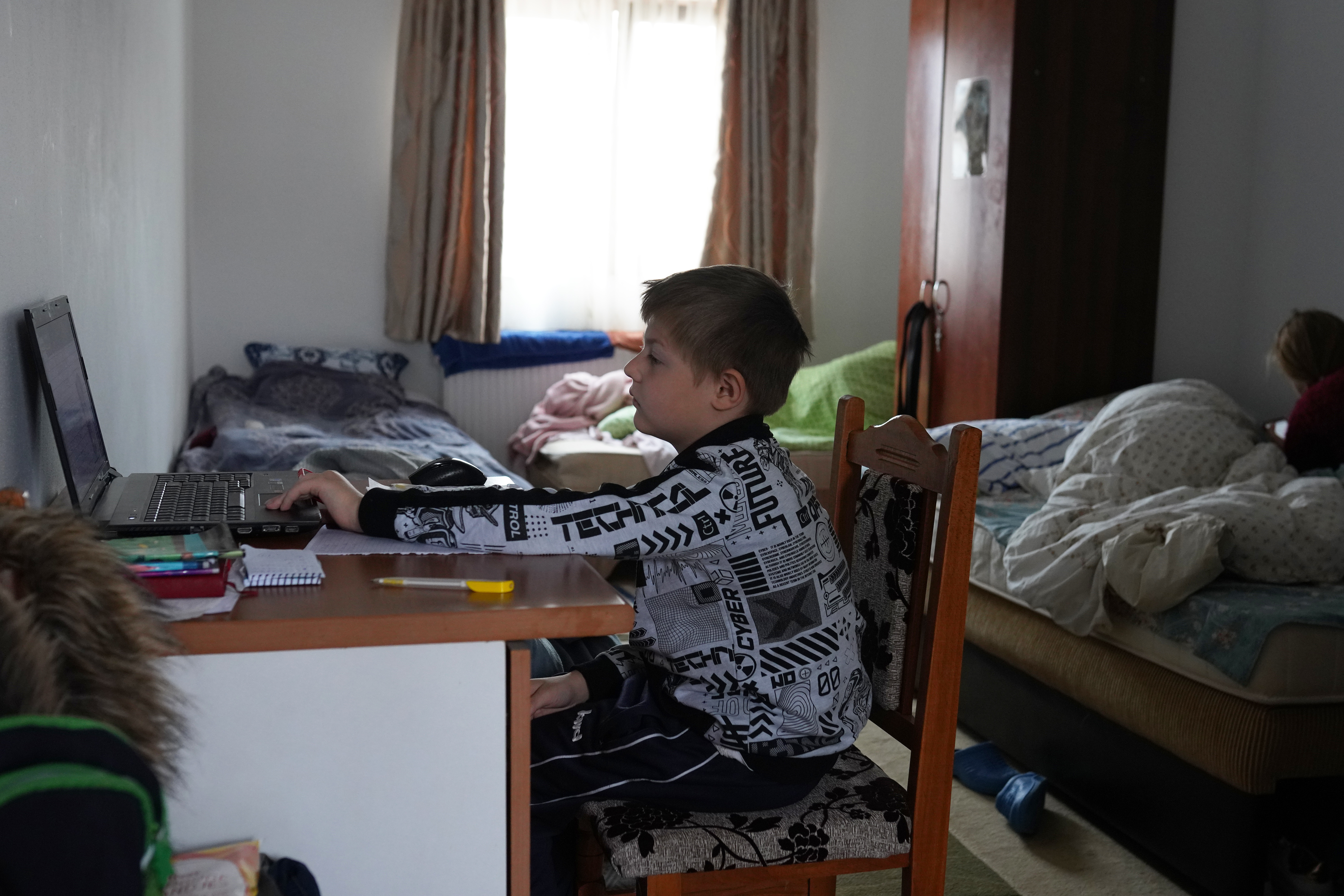 Dima, who fled the war in Ukraine with his mother, attends an online class, at the "Saint John the Baptist" Monastery in Ruscova, where 12 Ukrainians are currently being hosted, on March 30, 2022 in Ruscova, Romania. (Getty Images)
