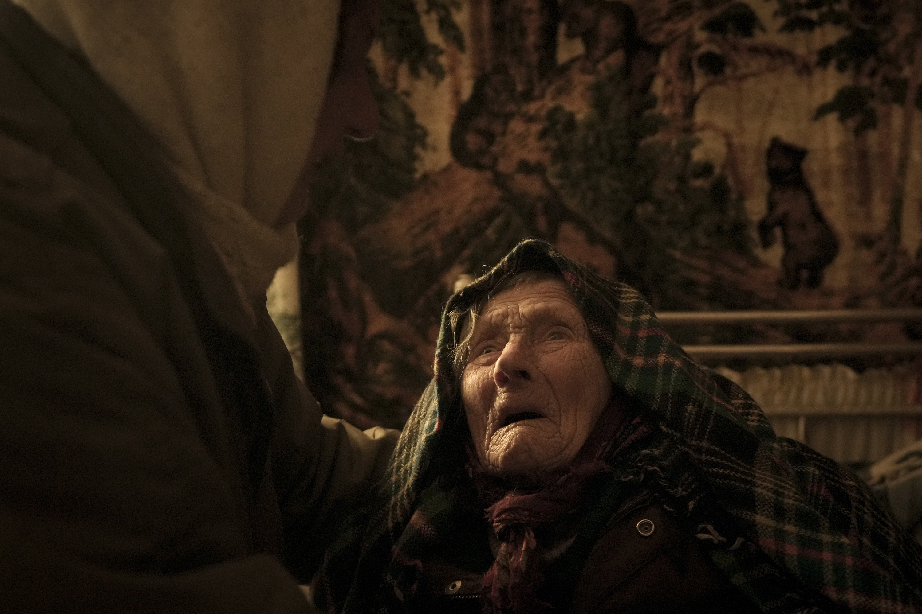 April 6: Motria Oleksiienko, 99, traumatized by the Russian occupation, is comforted by daughter-in-law Tetiana Oleksiienko in a room without heat in the village of Andriivka, in eastern Ukraine.