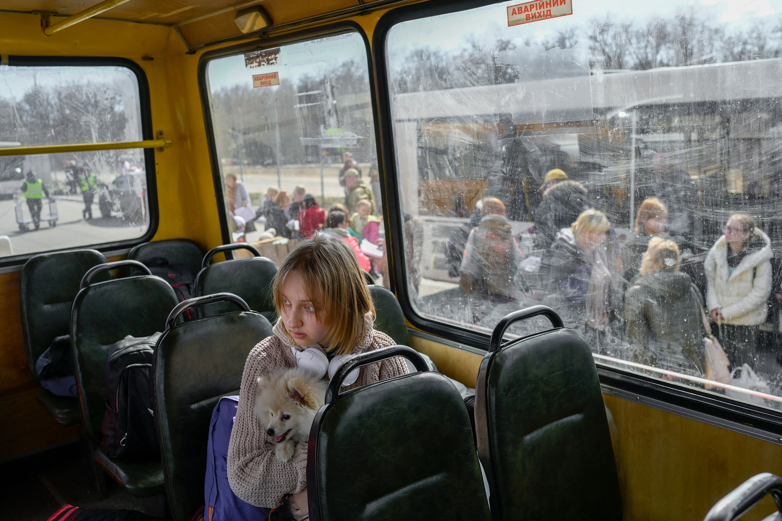 April 6: A young girl and her dog arrive at a center for internally displaced persons in Zaporizhzhia, some 124 miles northwest of Mariupol.