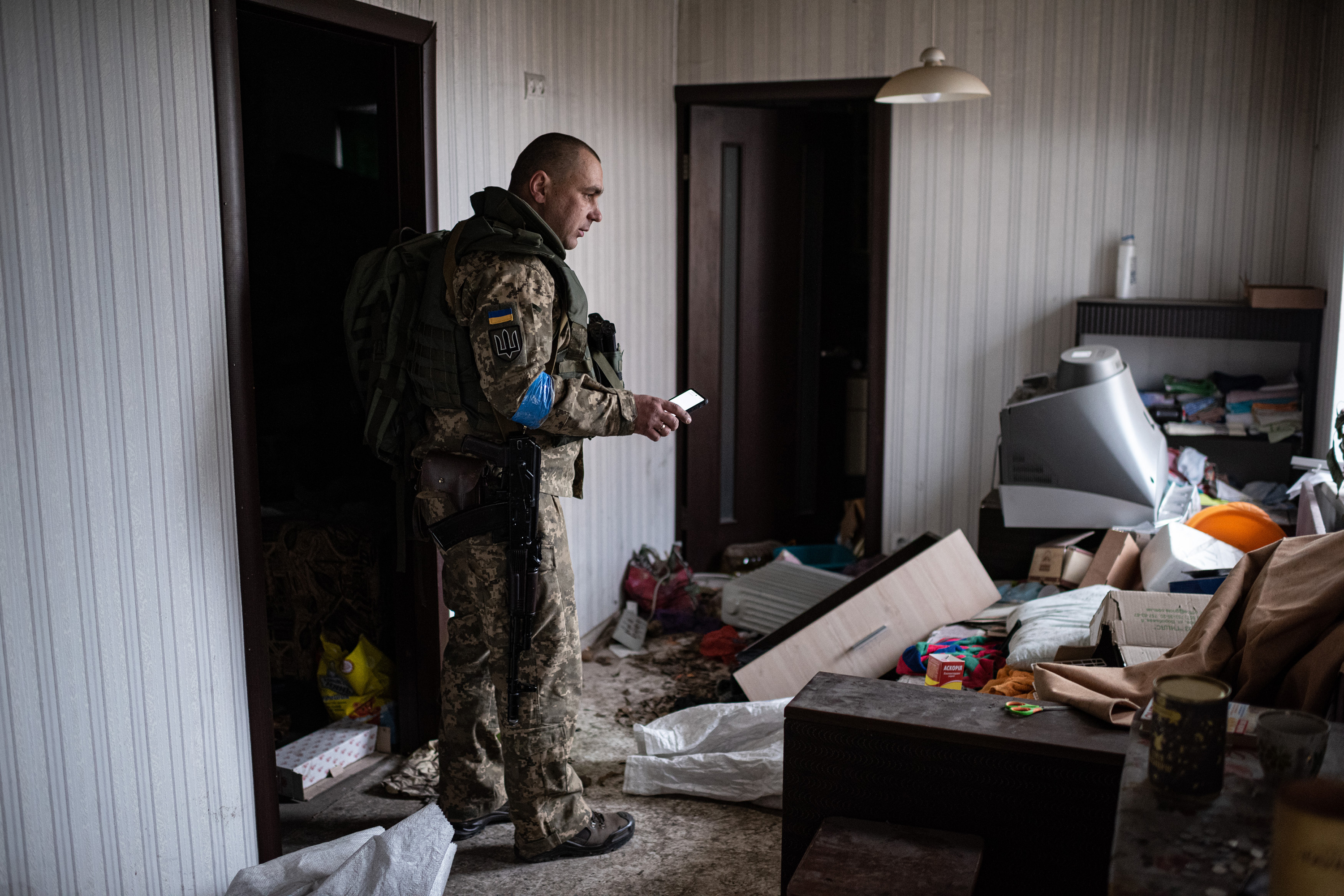 April 6: Yurii, 41, who serves in the Ukrainian military, stands in his apartment in Hostomel, on the outskirts of Kyiv, as he gathers things to take with him. The suburb of Ukraine's capital city was occupied for more than a month by Russian forces until they retreated to Belarus last week.