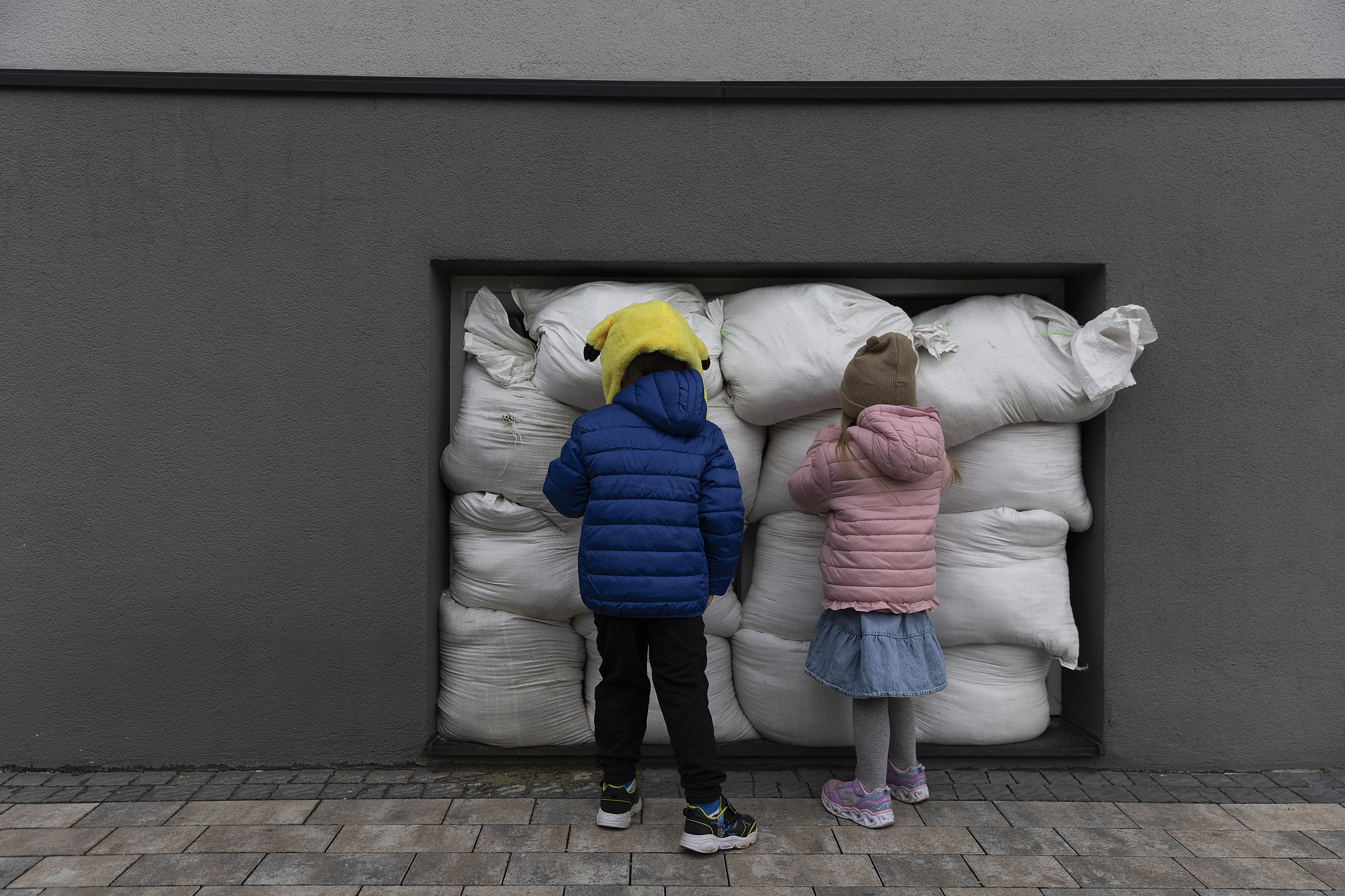 April 6: Children look at the sandbags that cover the windows at the Smart English pre-school in Lviv, in western Ukraine. The sandbags were put in place to help lessen the potential impact of an air strike amid Russia's ongoing invasion.