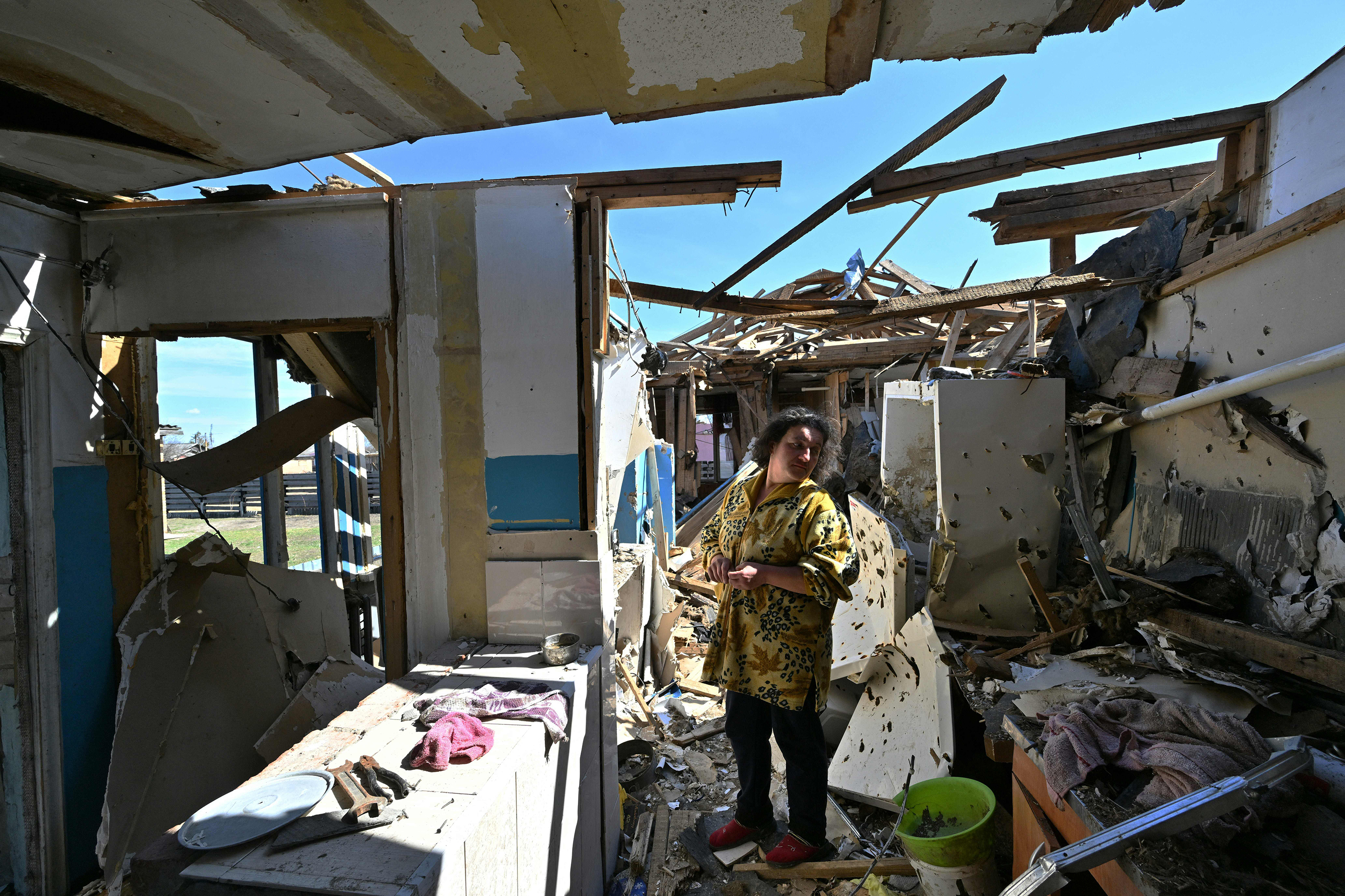 April 7: A woman surveys the damage to her home in the outskirts of Ivankiv, in northern Ukraine.