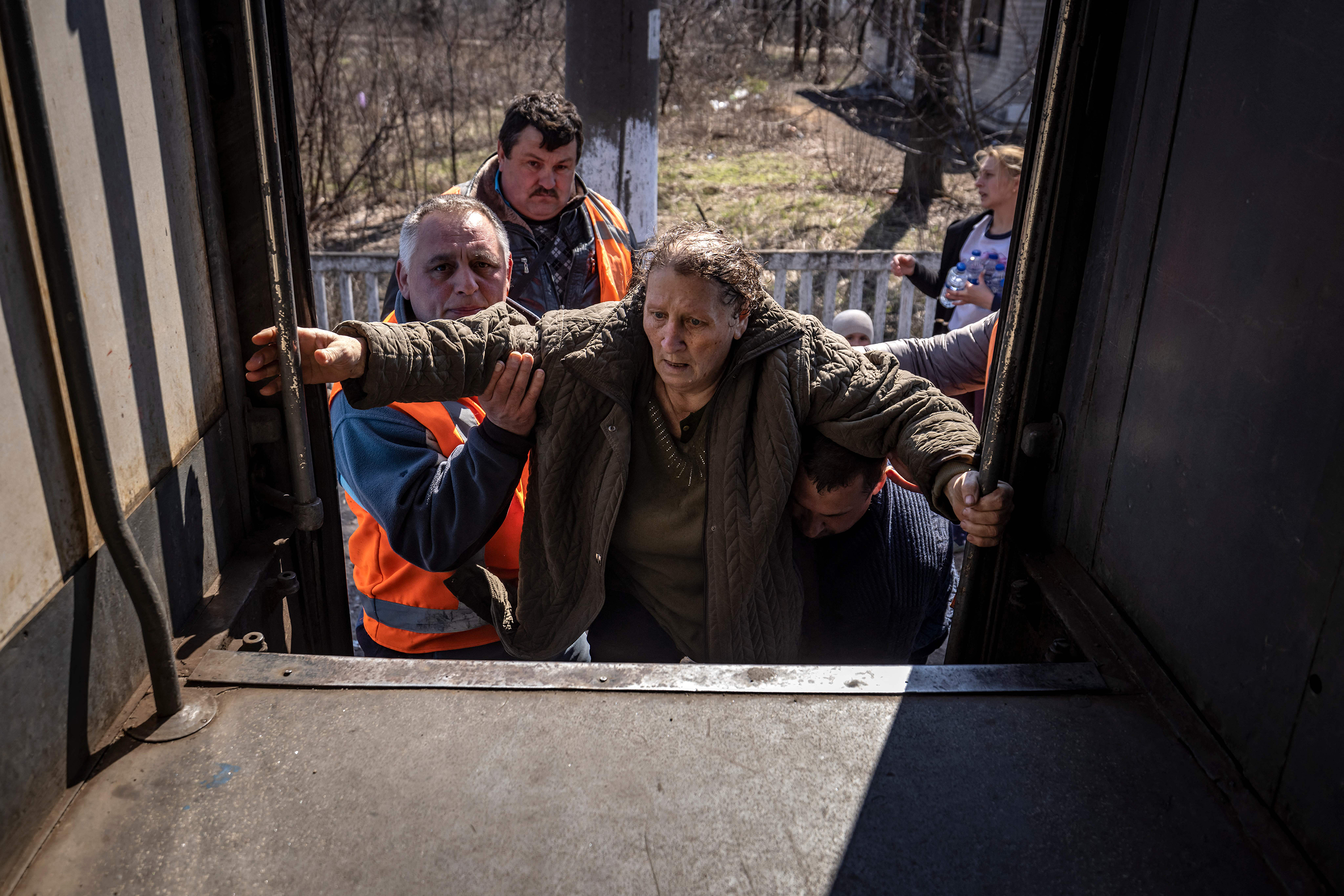 April 7: A woman is helped onto a train near Severodonetsk, as she tries to flee the country's Donbas region.