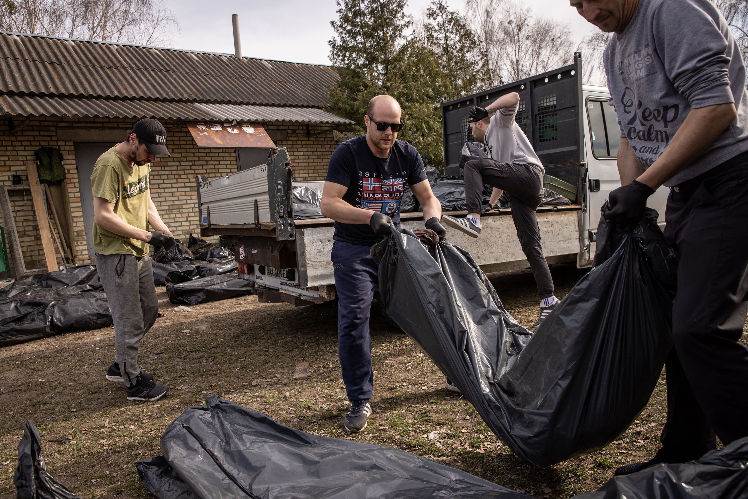 April 7: Cemetery workers unload the bodies of civilians killed in and around Bucha, on the outskirts of Kyiv, before they're transported to the morgue.