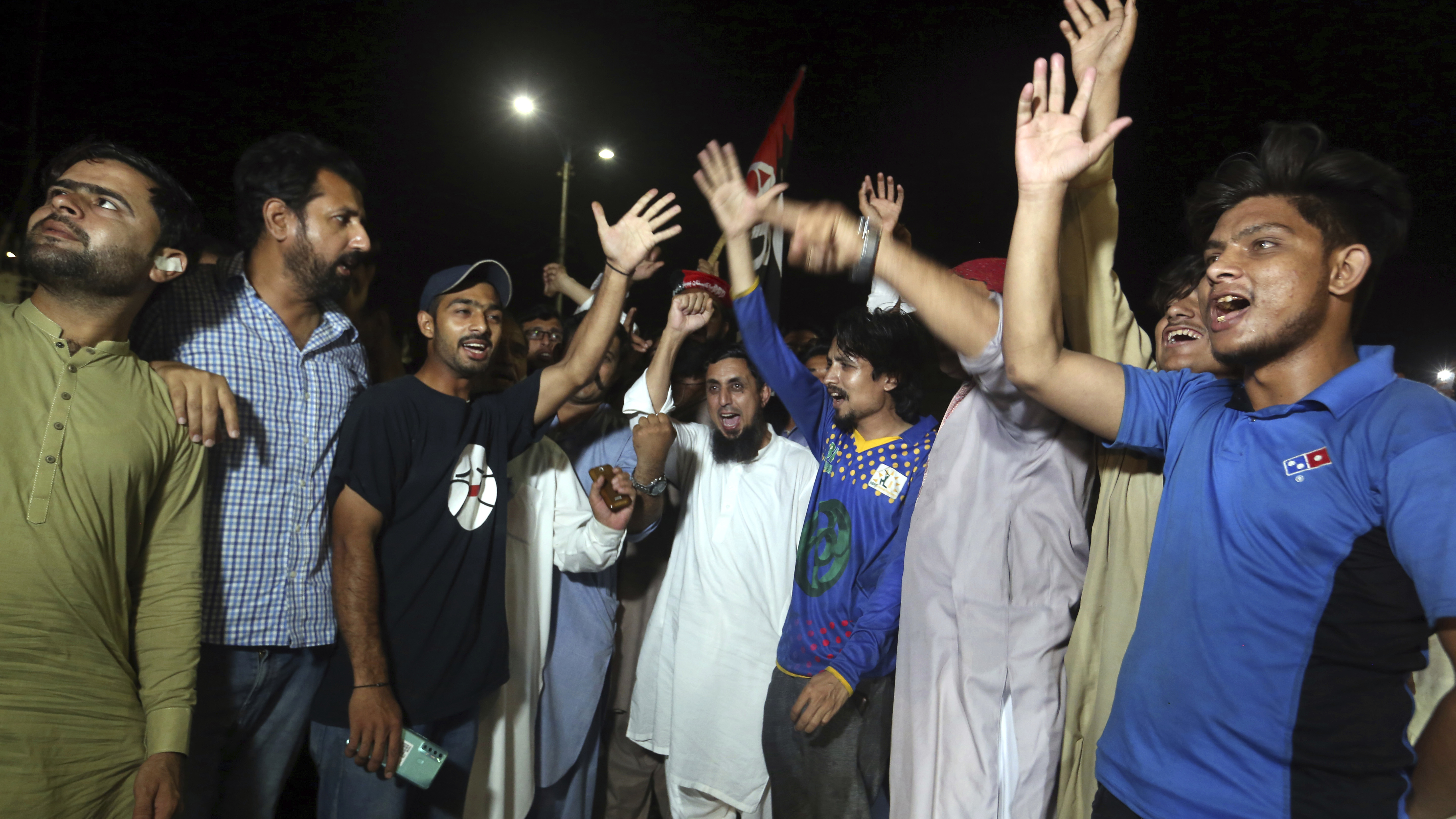 Supporters of an opposition party celebrate the success of a no-confidence vote against Prime Minister Imran Khan, in Karachi, Pakistan, Sunday, April 10, 2022.