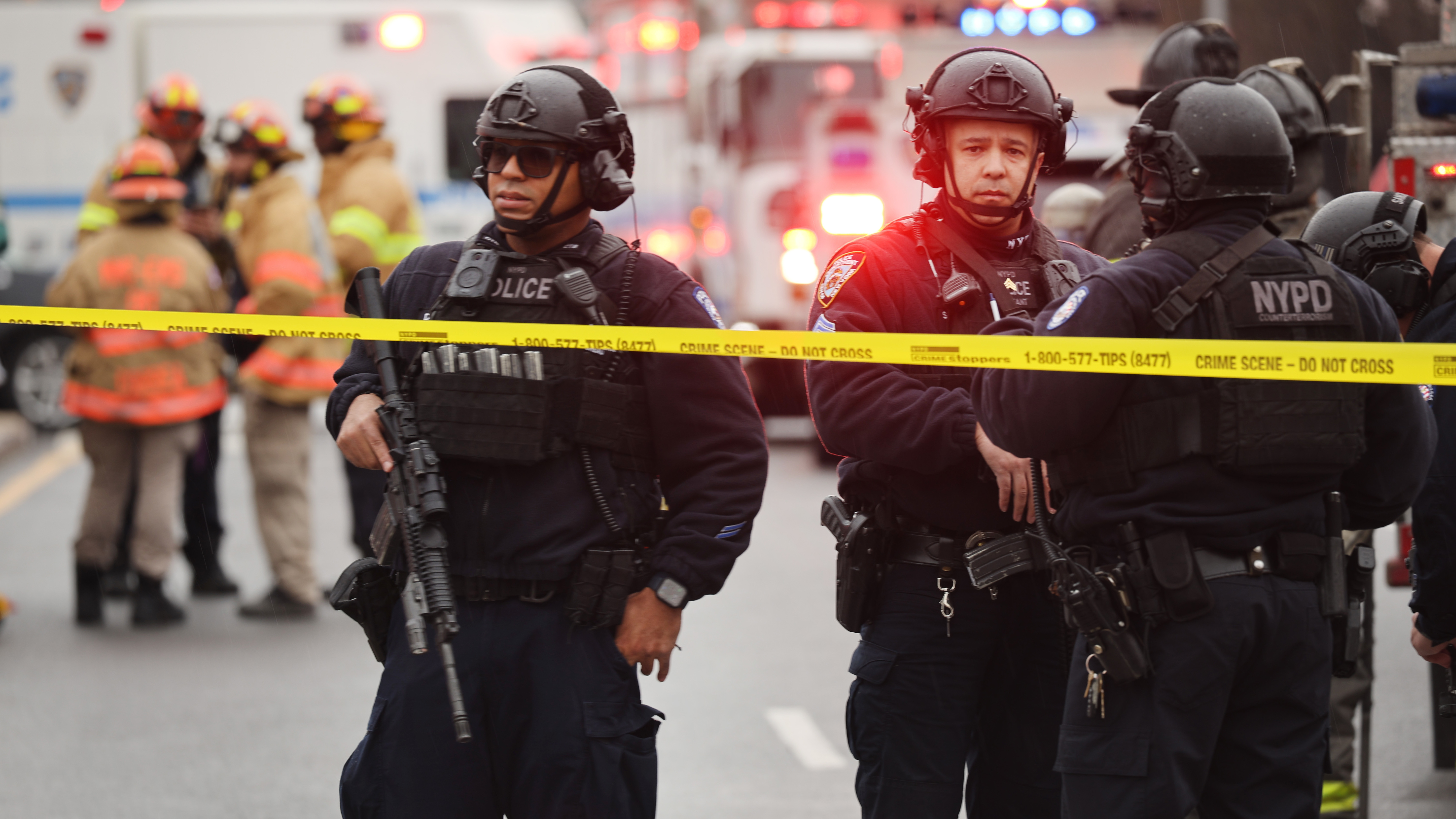 Police and emergency responders gather at the site of a reported shooting of multiple people outside of Brooklyn
