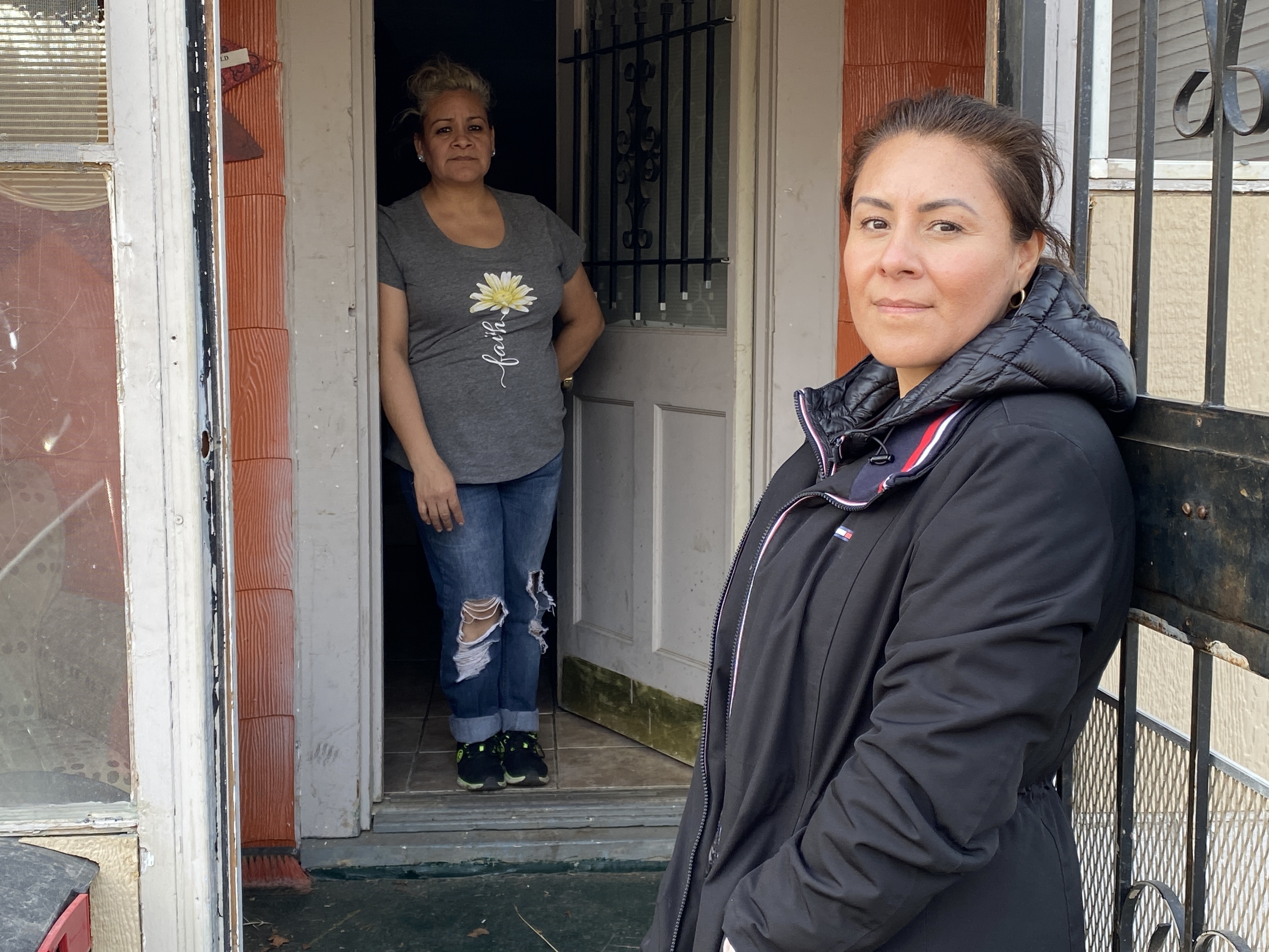 Marisela Orozco (foreground) is letting her sister, Marissa, live in the house she thought she would own after making almost four years of payments. But the owner disappeared, along with the title, and she worries he may return and evict them.