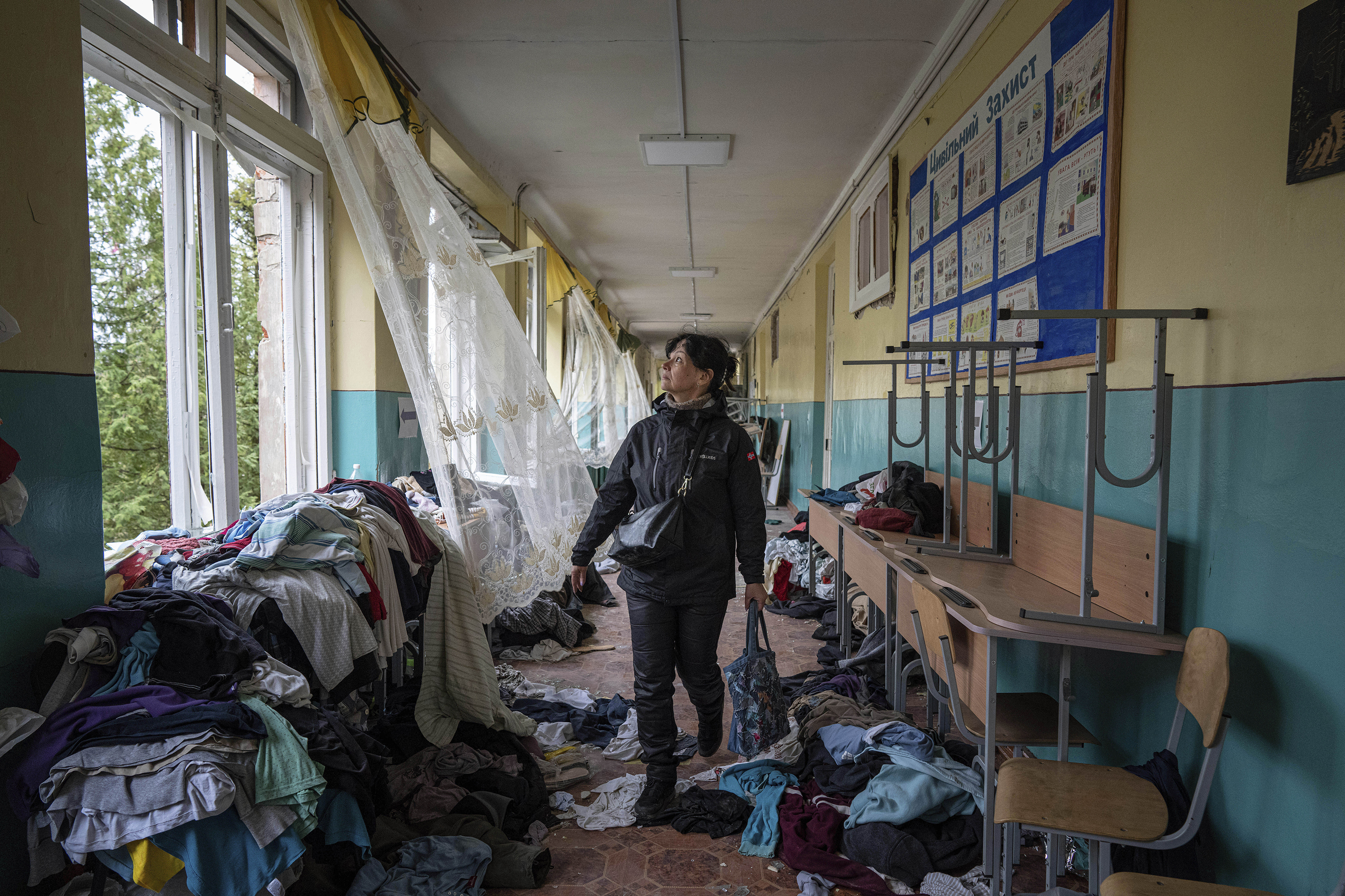 April 13: Iryna Homenko, a school director, walks down the hall of a Chernihiv school damaged in a Russian airstrike.
