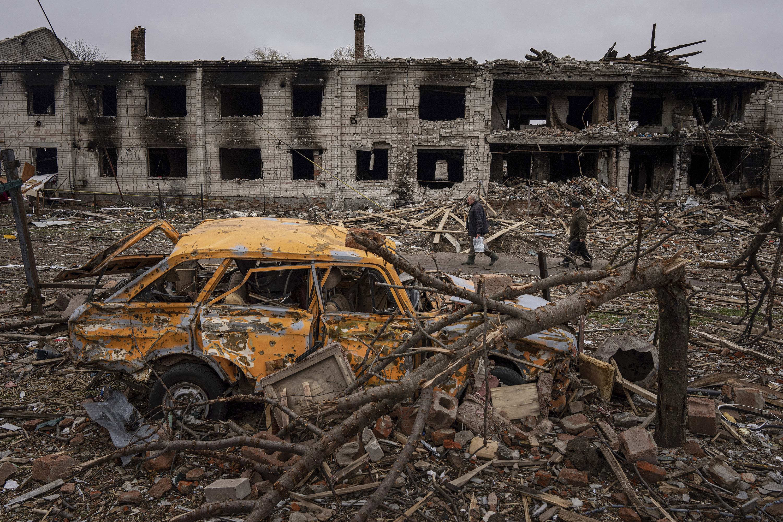 April 13: Men walk along a street destroyed by shellings in Chernihiv, in northern Ukraine.
