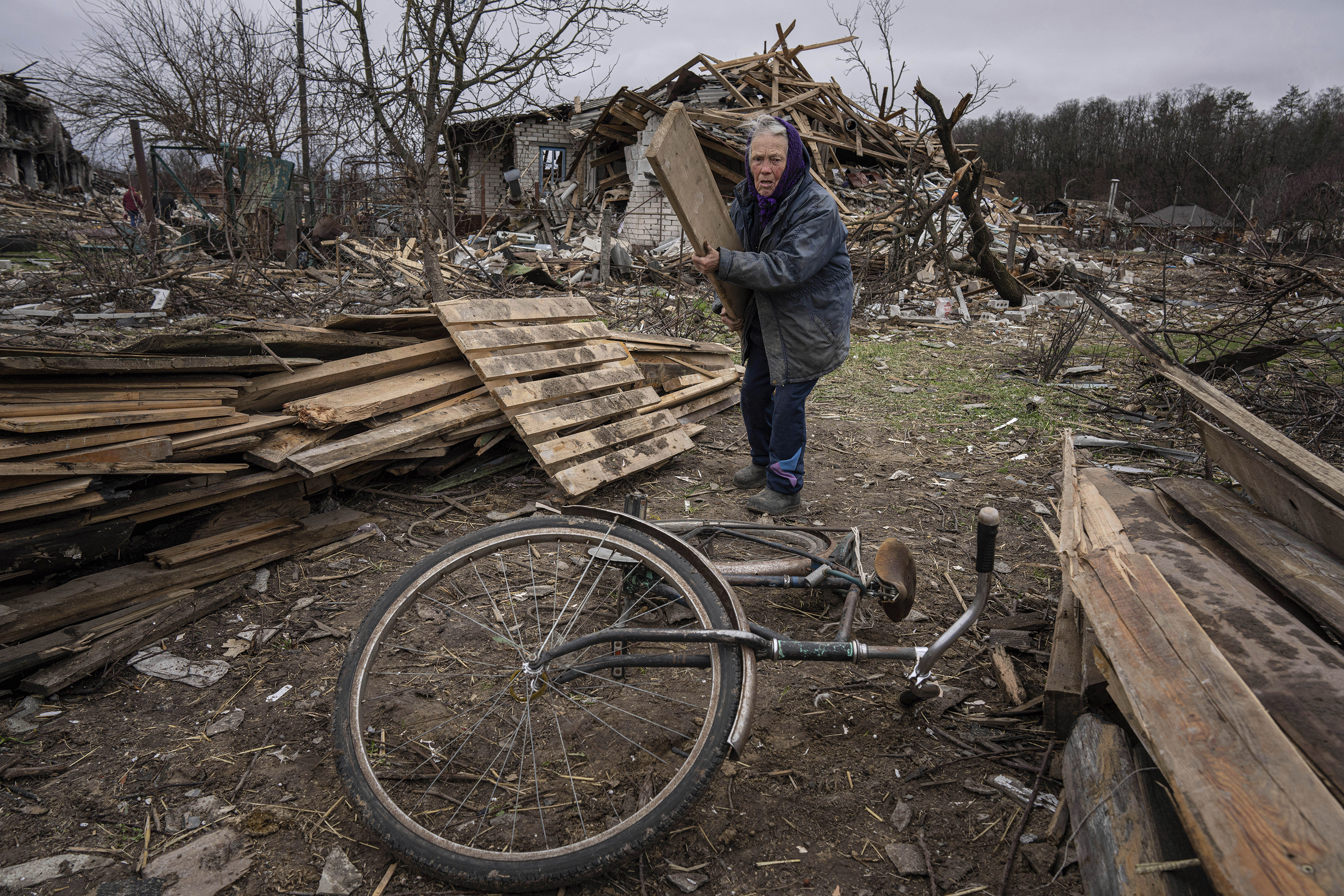 April 13: A woman collects wooden planks in a street destroyed by shellings in Chernihiv, in northern Ukraine.
