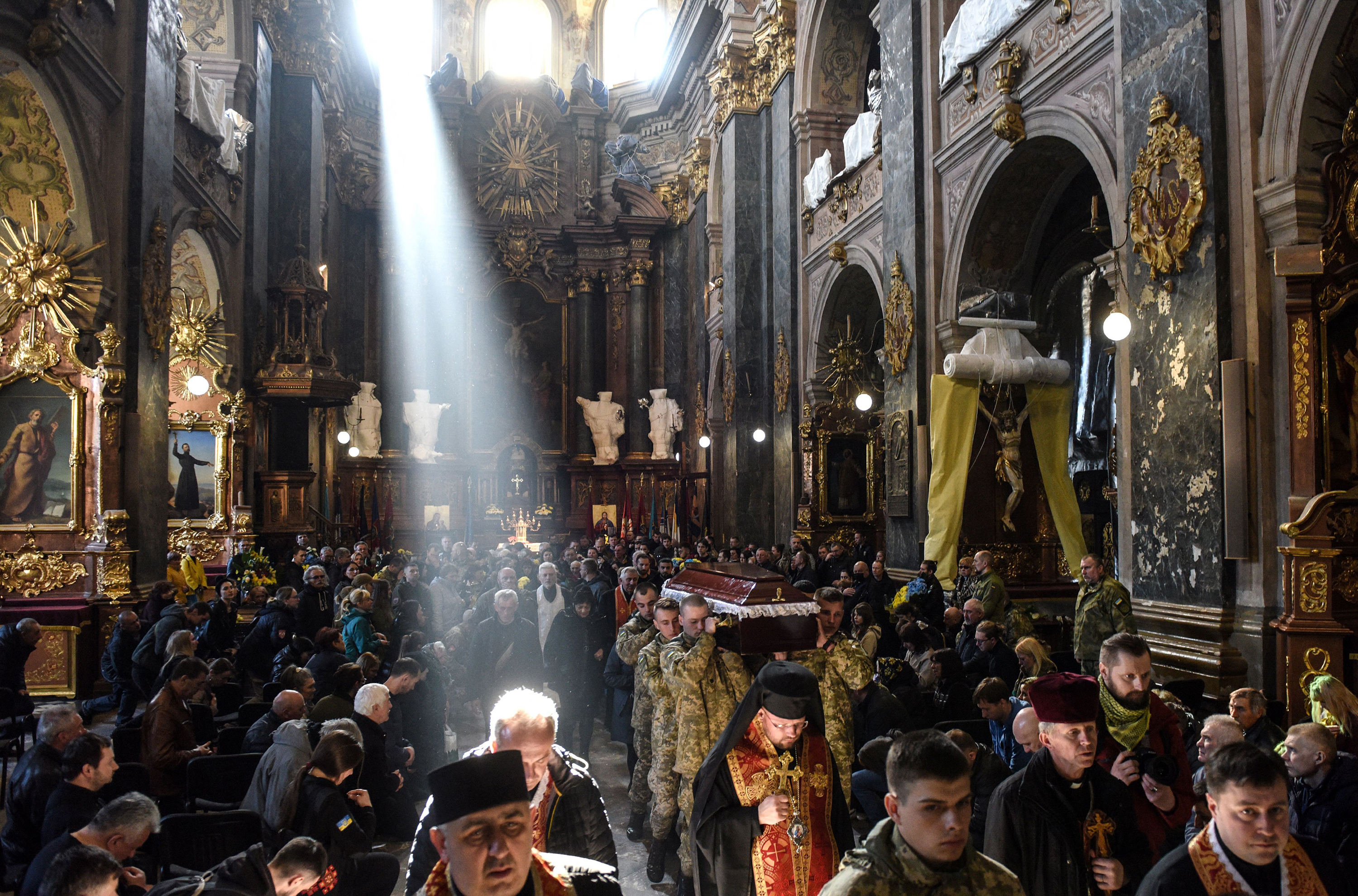 April 13: Mourners attend a memorial service for officer Taras Bobanych — whose call sign was "Hammer" — of Right Sector, the Ukrainian Volunteer Corps, at the Saints Peter and Paul Garrison Church in Lviv, in western Ukraine.