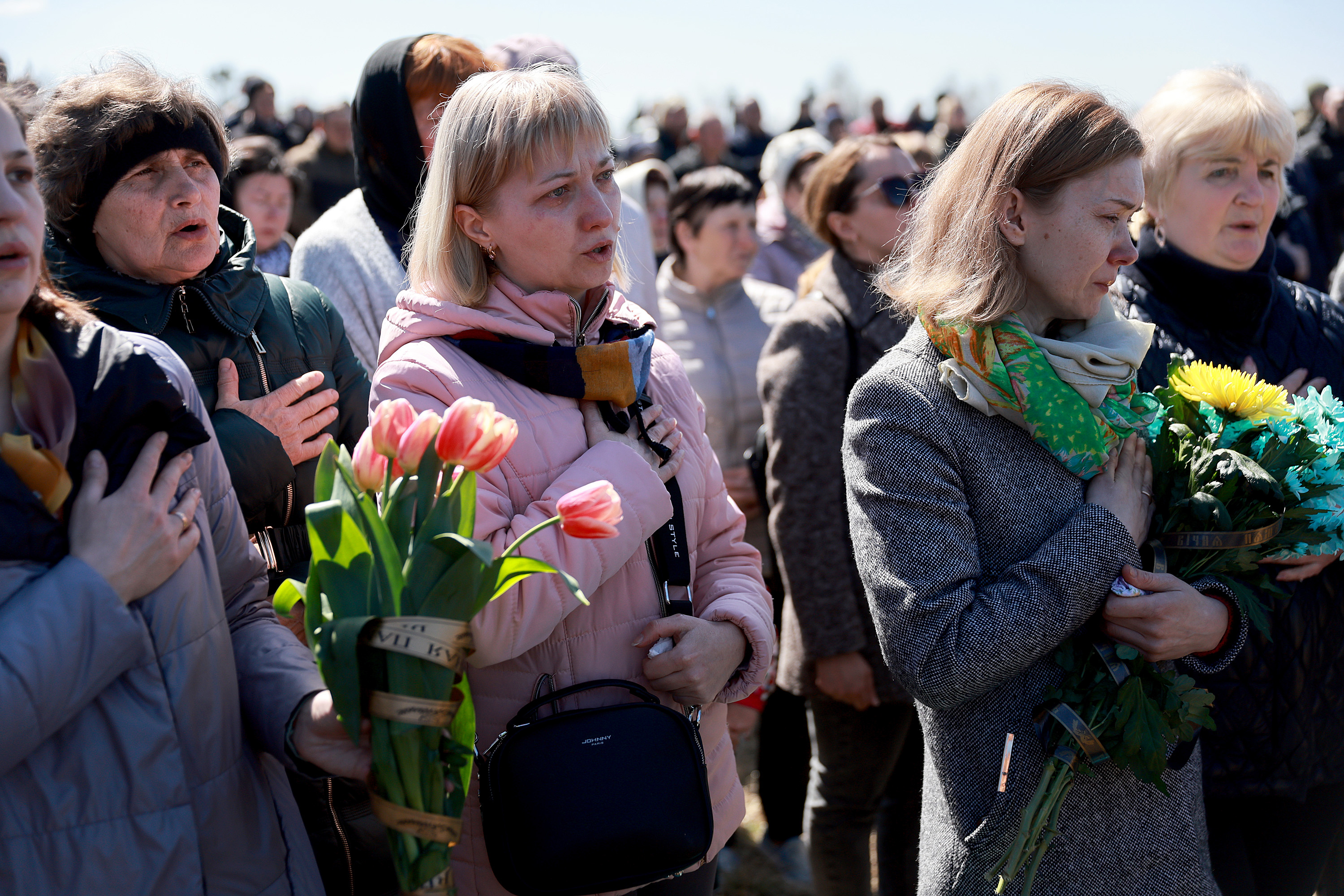 April 13: Mourners sing the Ukrainian national anthem during the burial of Ukrainian soldier Oleksandr Goshko in Starychi, in western Ukraine. Goshko died fighting Russian invaders near the town of Popasna, in the Luhansk Oblast in eastern Ukraine.