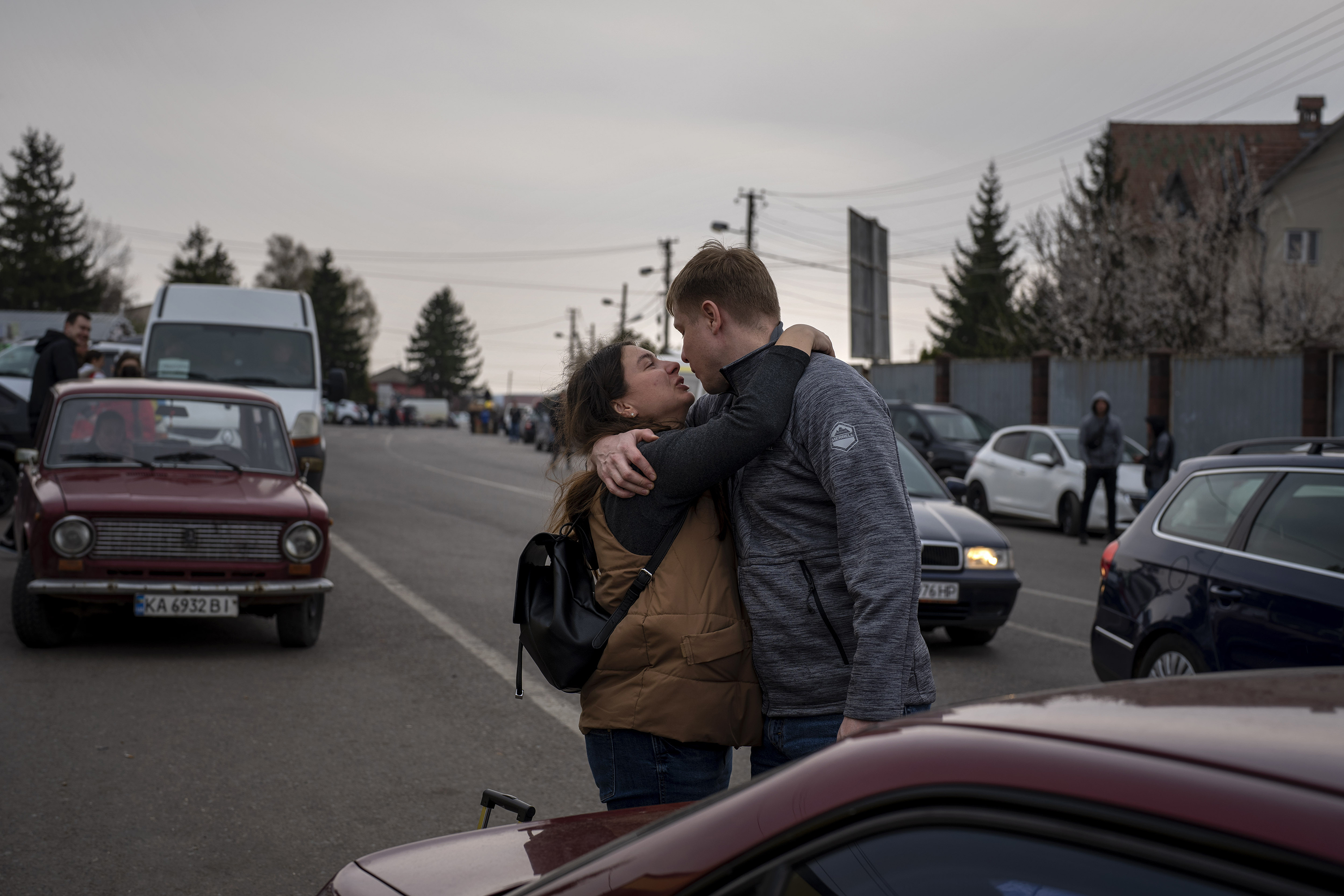 April 15: A Ukrainian couple say goodbye as she leaves for Poland to escape the war at the Shehyni border crossing, in Ukraine.