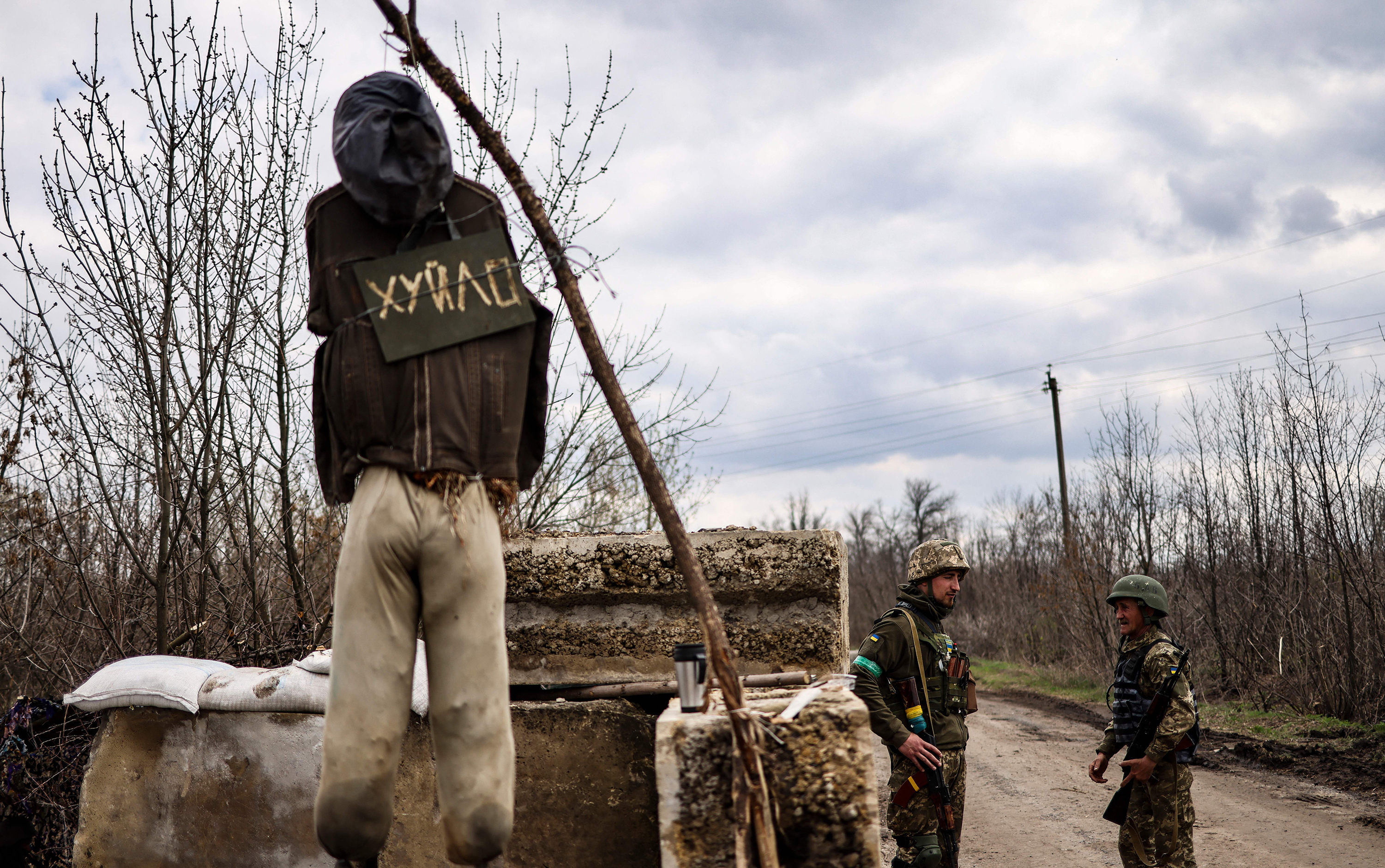 April 15: Ukrainian servicemen stand guard at a checkpoint on the outskirts of Barvinkove, eastern Ukraine.